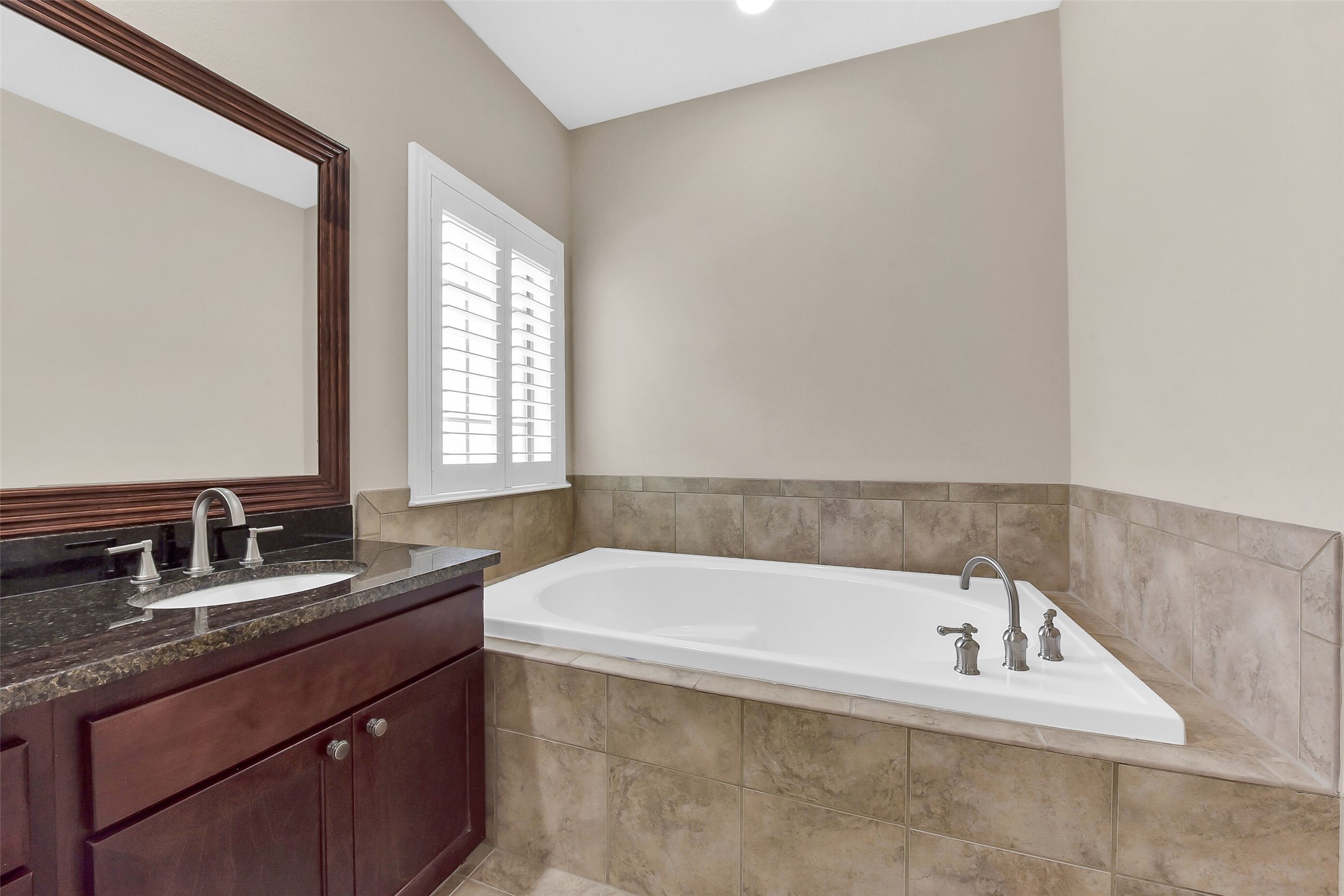 Soaking tub with tile surround makes a great place to relax.
