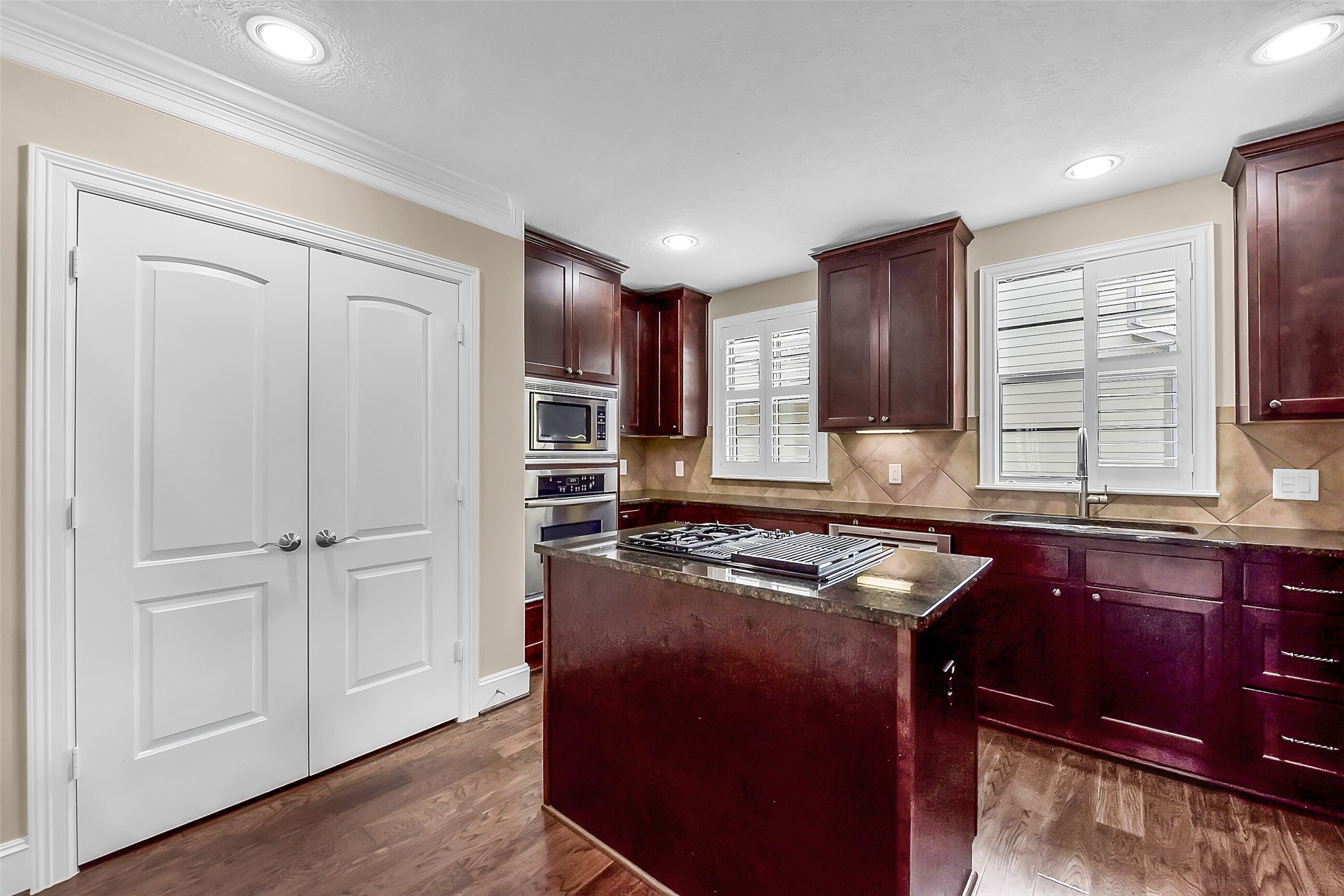 Double doored pantry is within easy reach of the island.