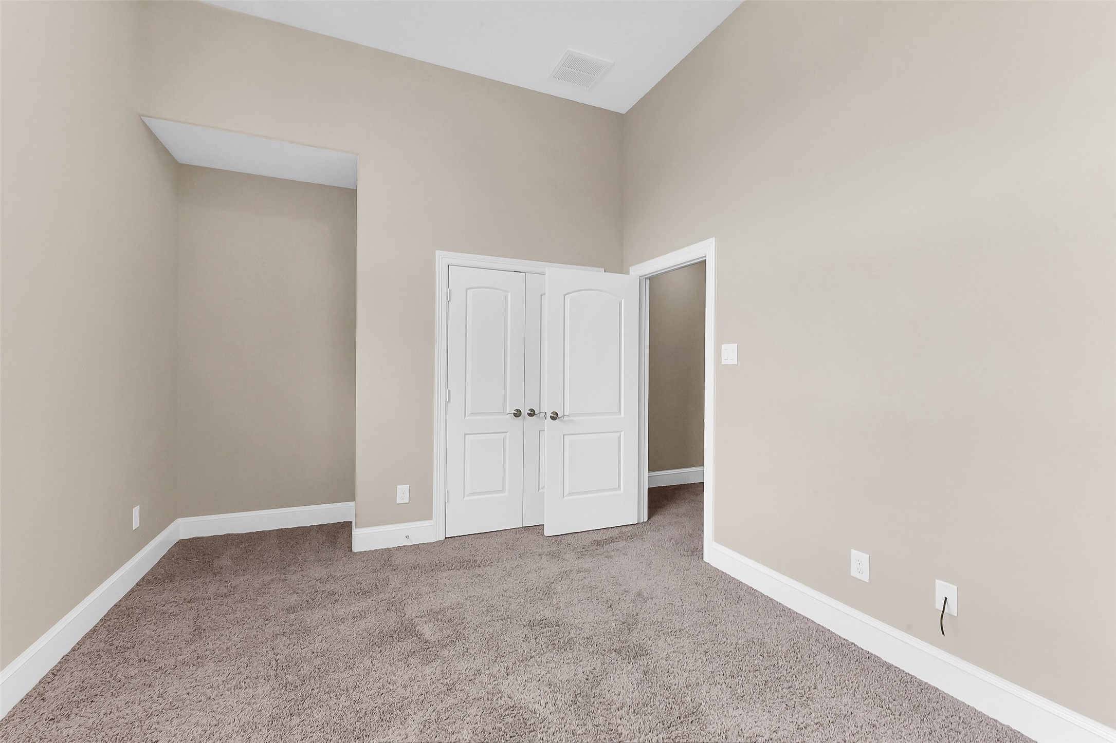 Another view of the third floor secondary bedroom with enough room to tuck a vanity next to the closet.