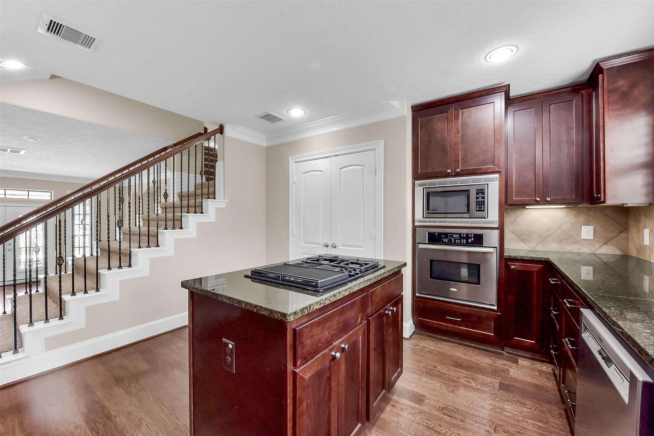 Cabinets in the island contribute to extra storage space.