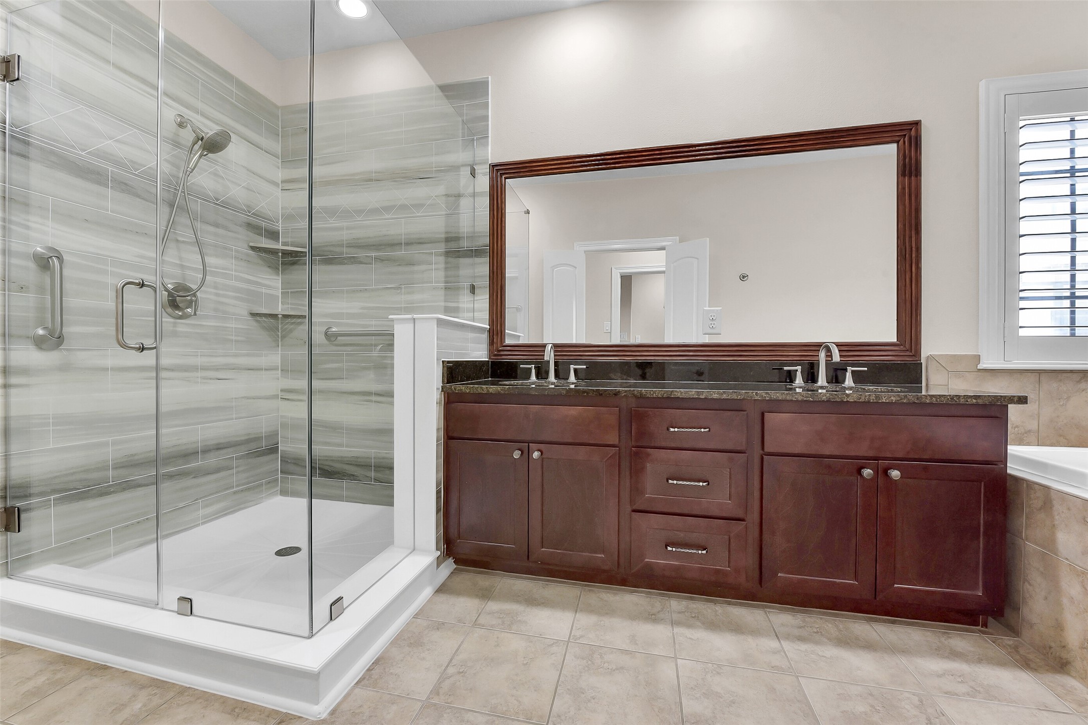 In addition to the oversized shower, the large vanity houses two sinks, plus canbinets and drawers for storage.