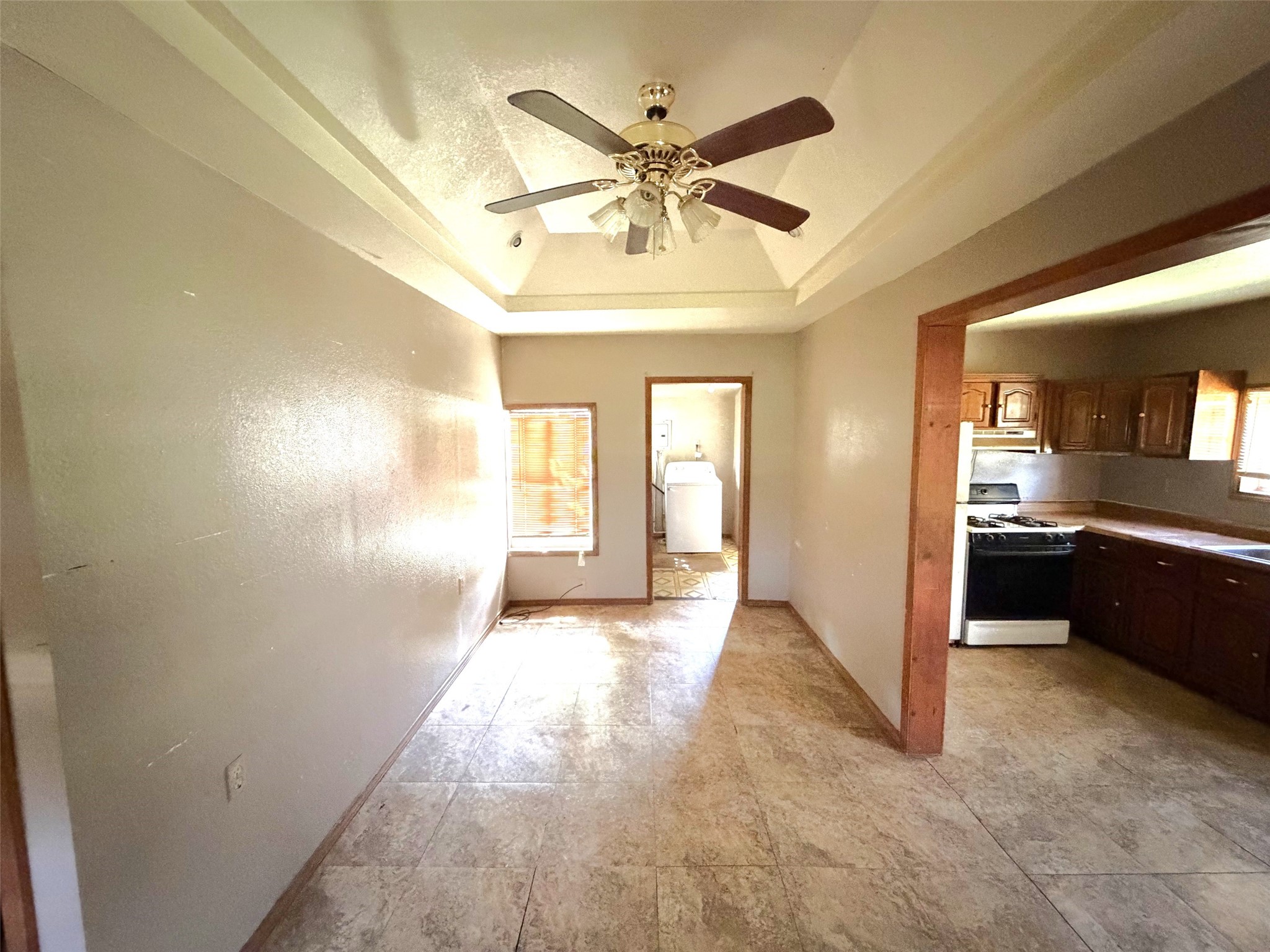 Stepping inside the first house, you enter the living area with the utility room and bathroom straight ahead and the kitchen on your right.