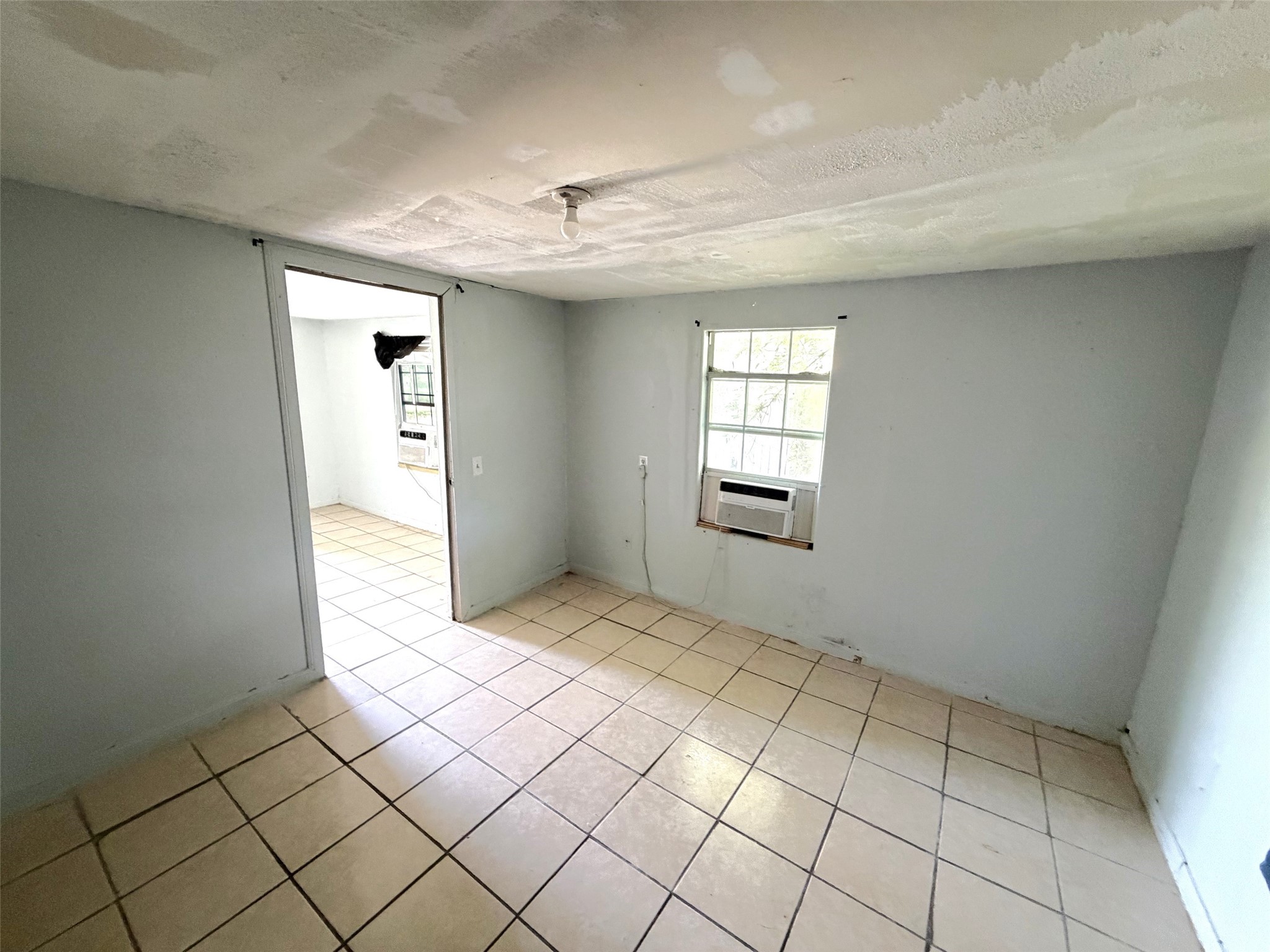 The bedroom of the second house is off the living area.