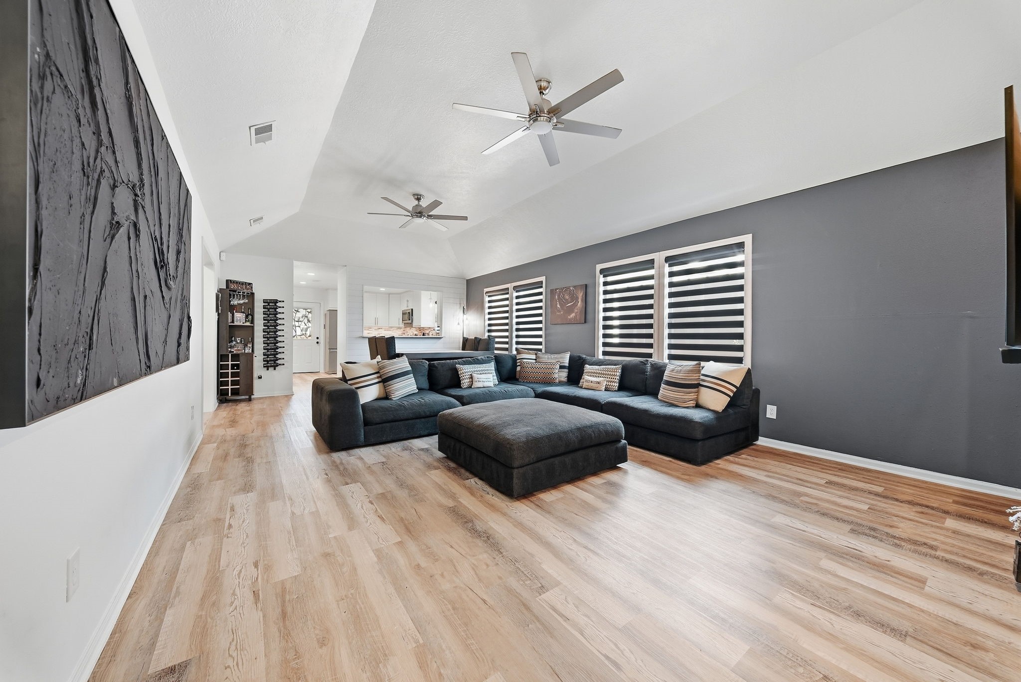 Spacious, light-filled living area featuring an open floor plan that is perfect for entertaining guests.