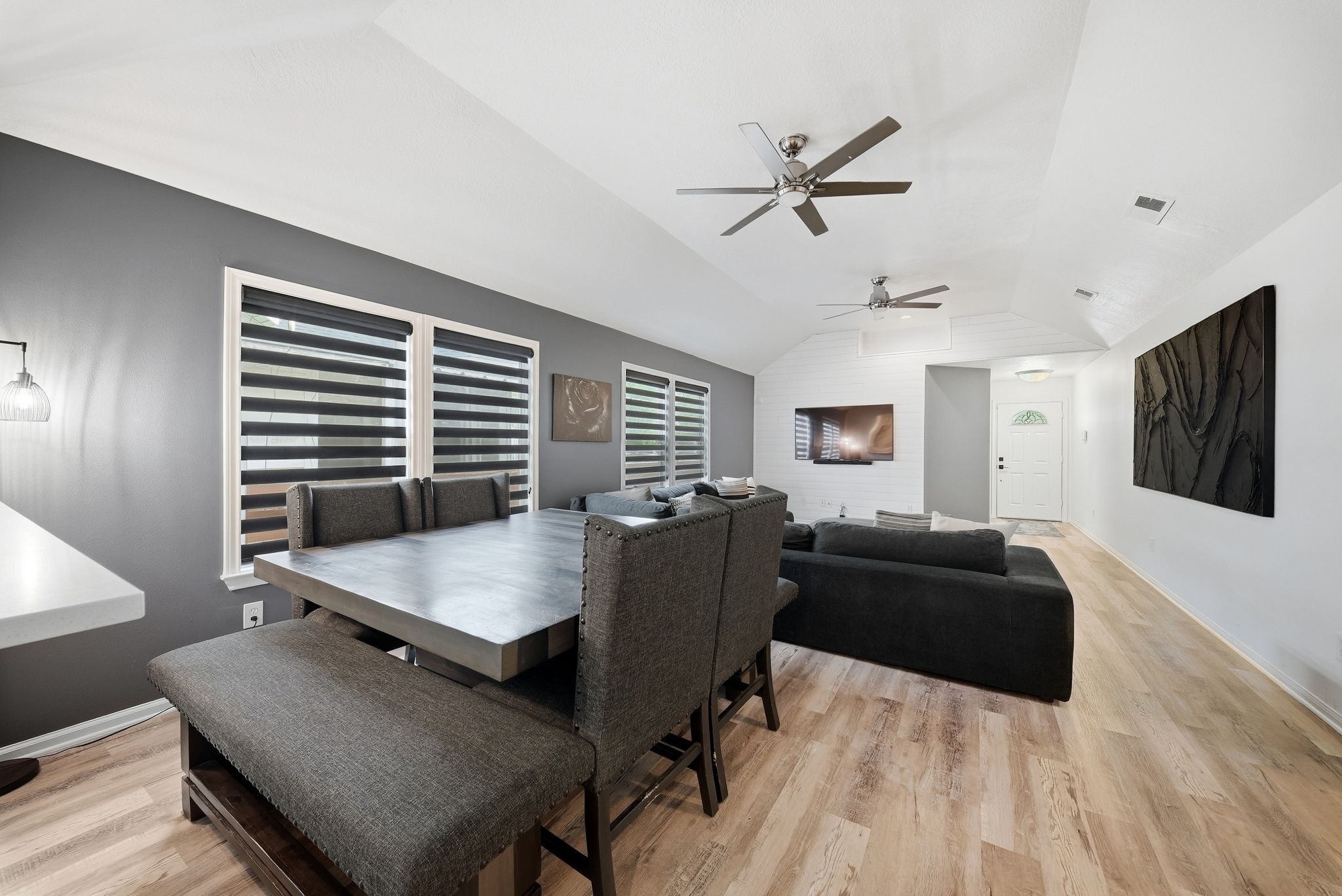Open-concept living and dining area featuring high ceilings.