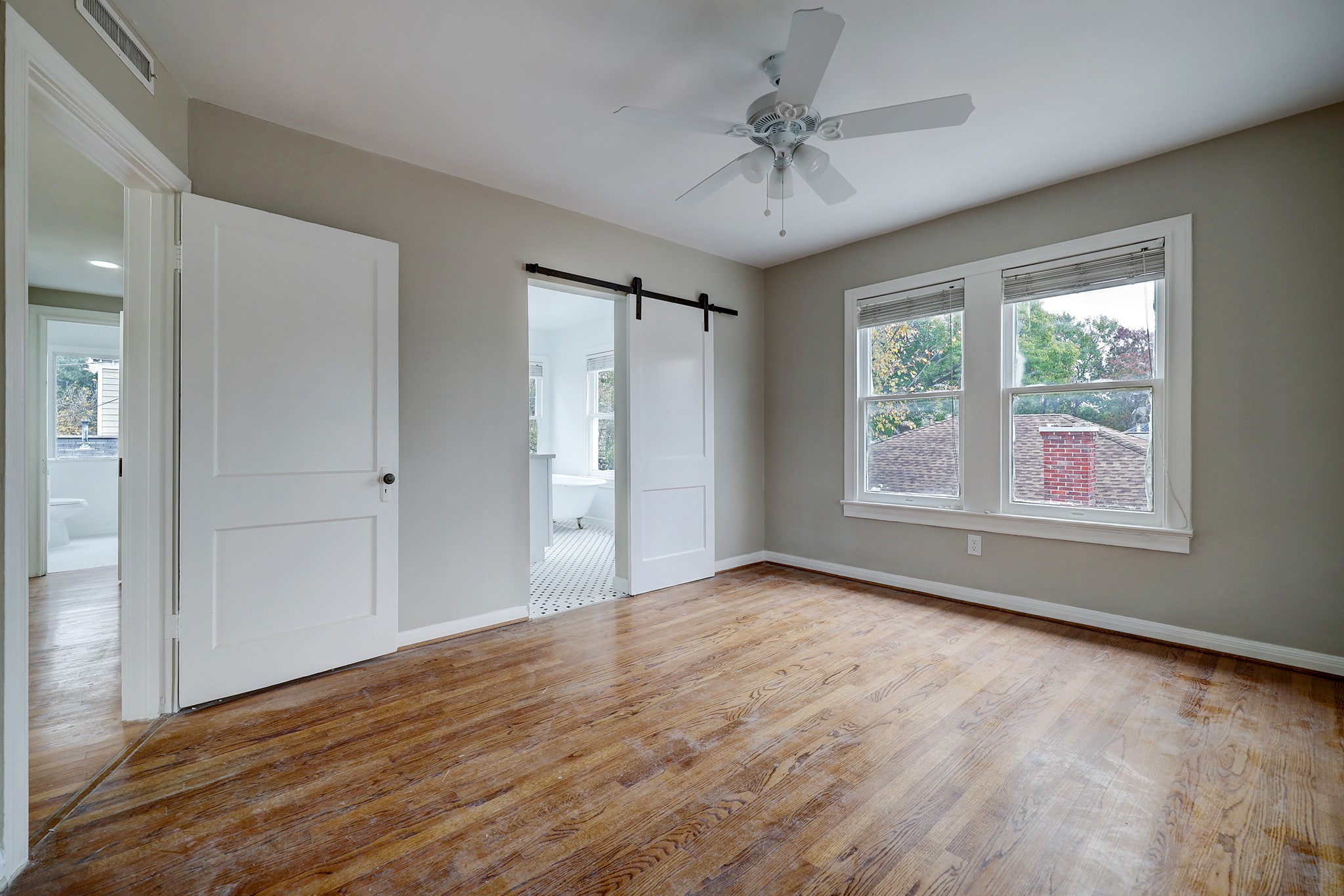 Barn door entry to primary bath