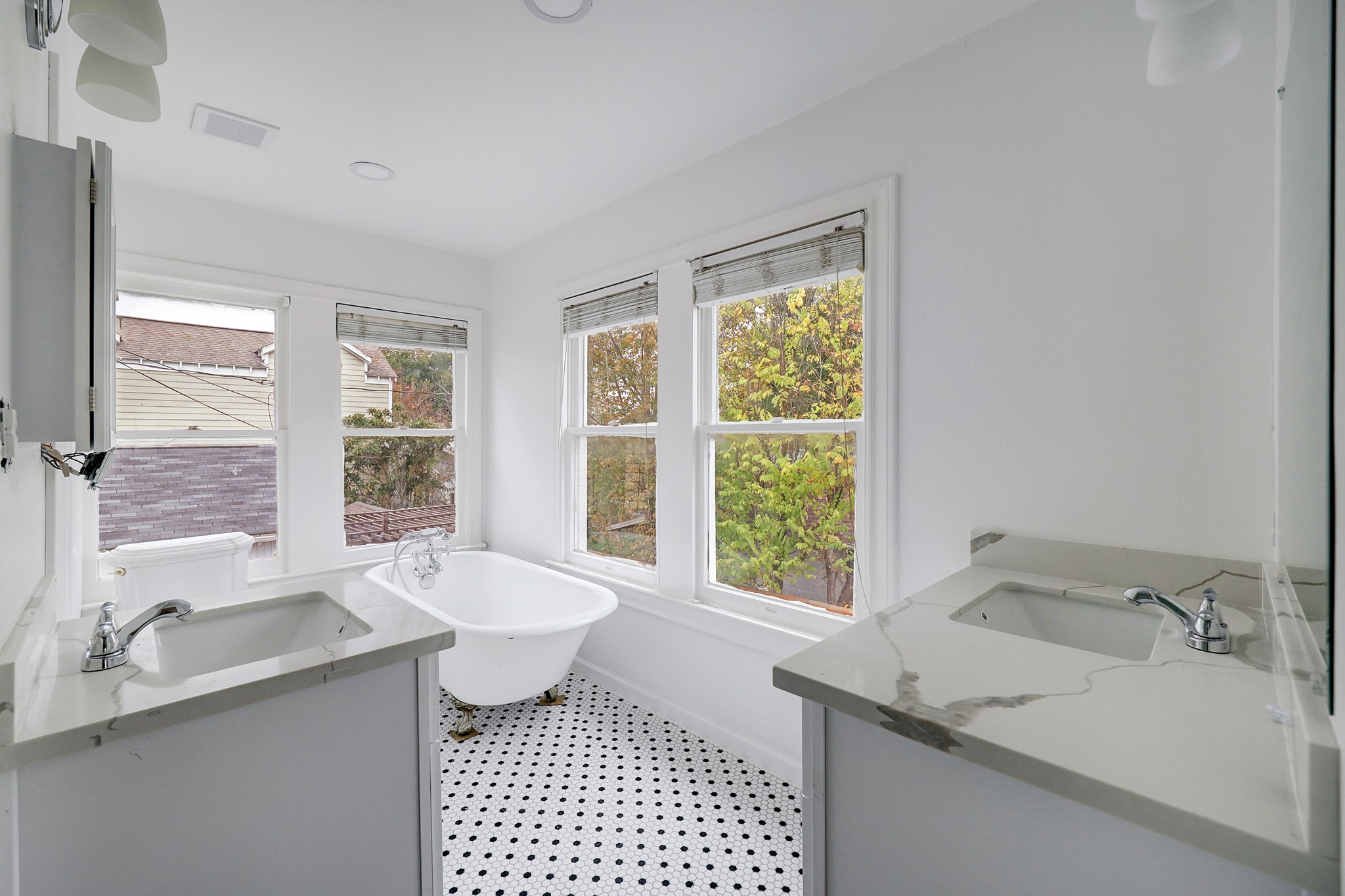 New primary bath features double vanities and clawfoot soaking tub