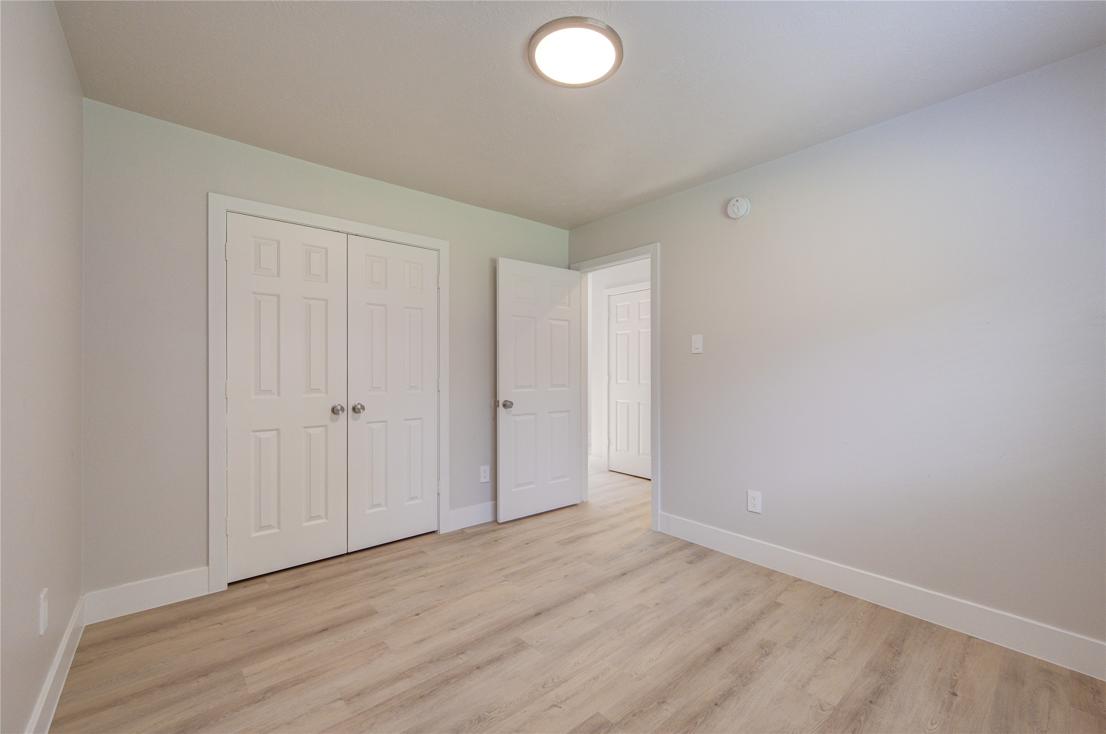 Generously sized secondary bedroom featuring fresh paint, new flooring, ample closet space and a flexible layout