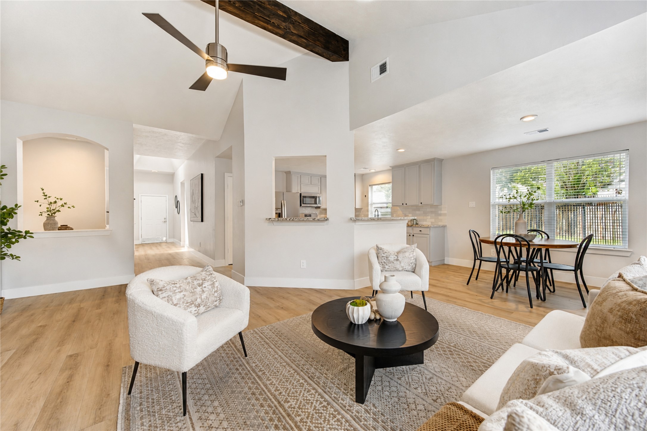 Everyday living in this bright, open-concept space, where soaring ceilings and seamless connections between the living room, kitchen and breakfast area make gathering and entertaining feel effortless