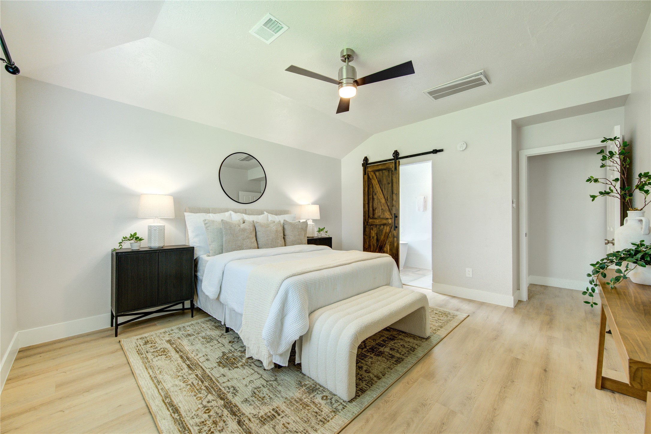 Barn door separates Primary Bed from Bath