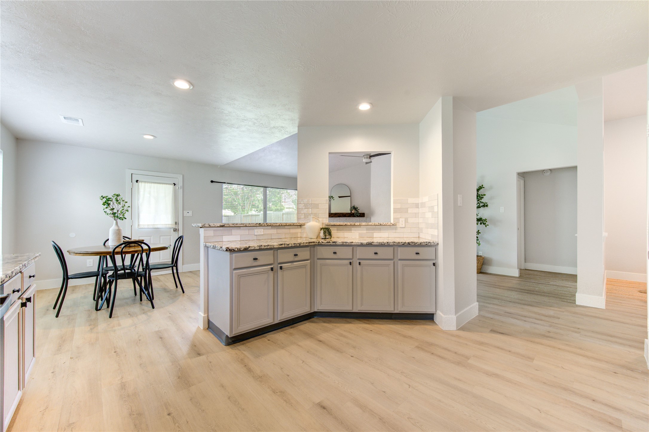 Panoramic view capturing the homes sophisticated open-concept design, where the kitchen, breakfast area and living room connect