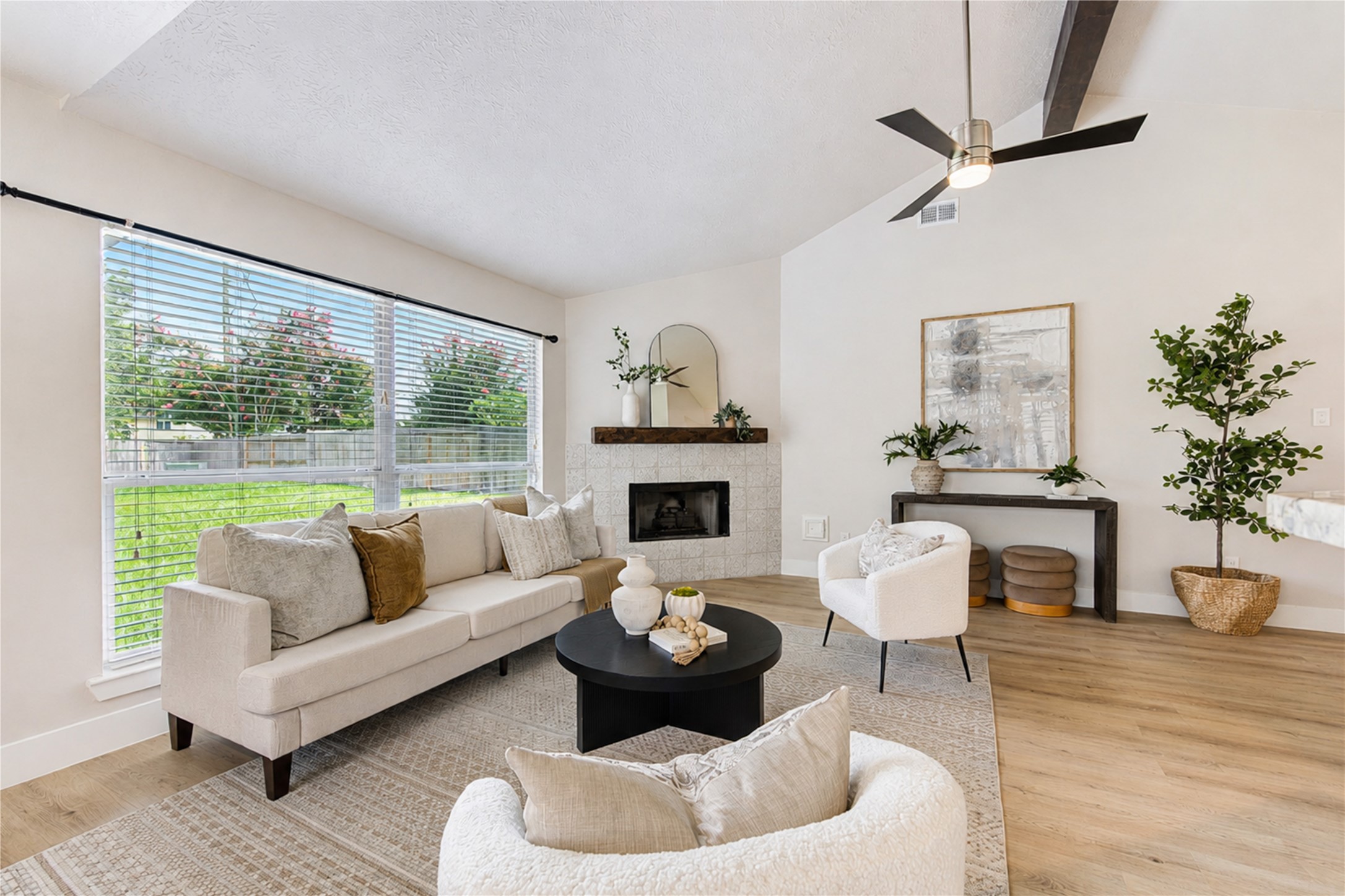 Envision gathering with family and friends in a light-filled living room anchored by a beautiful statement fireplace