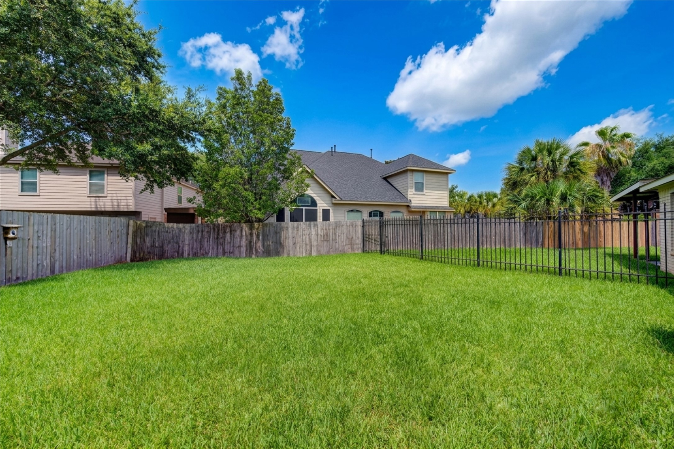 A generous backyard with an additional fenced section providing versatile outdoor spaces with endless possibilities for relaxation, play or future enhancements