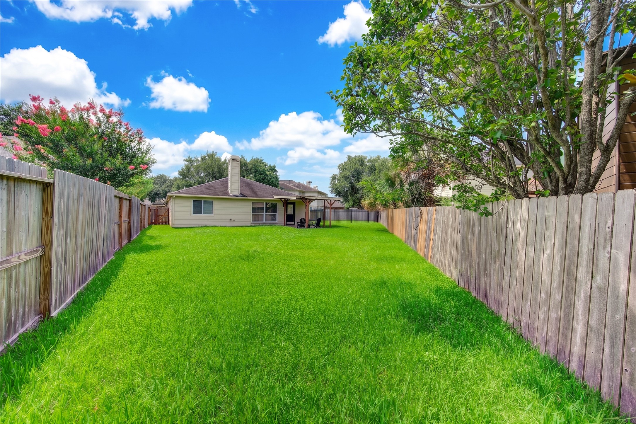An expansive, fully fenced backyard offering abundant space for outdoor entertaining, recreation or creating your own private retreat