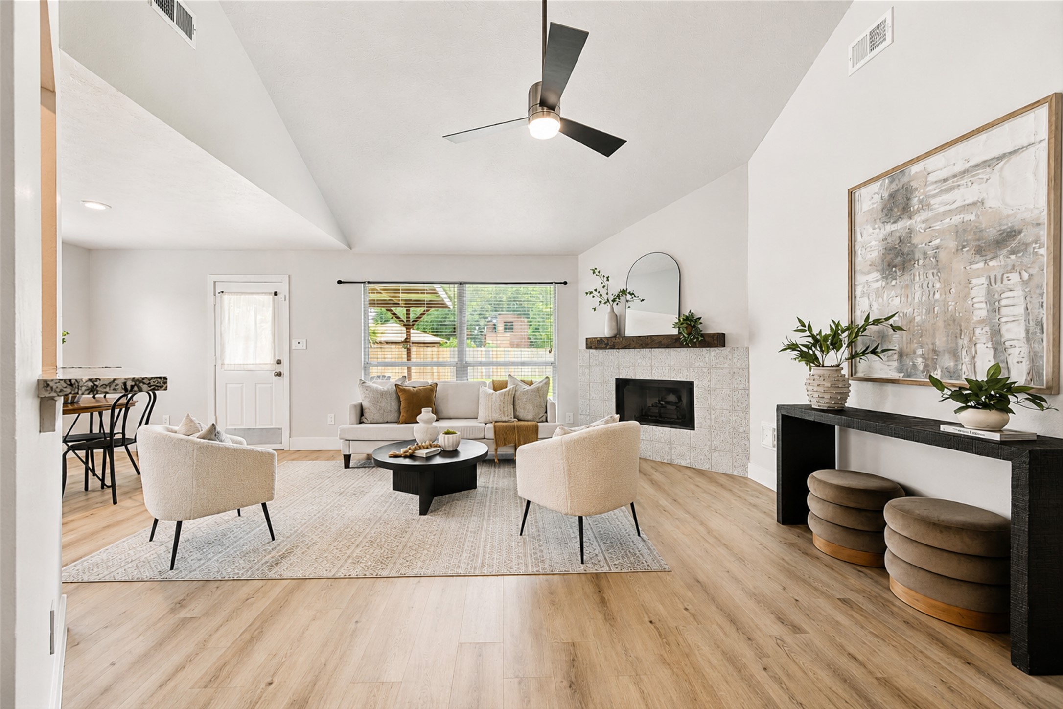 Staged to showcase an open-concept living area where soaring ceilings, natural light and easy access to the kitchen create the heart of the home