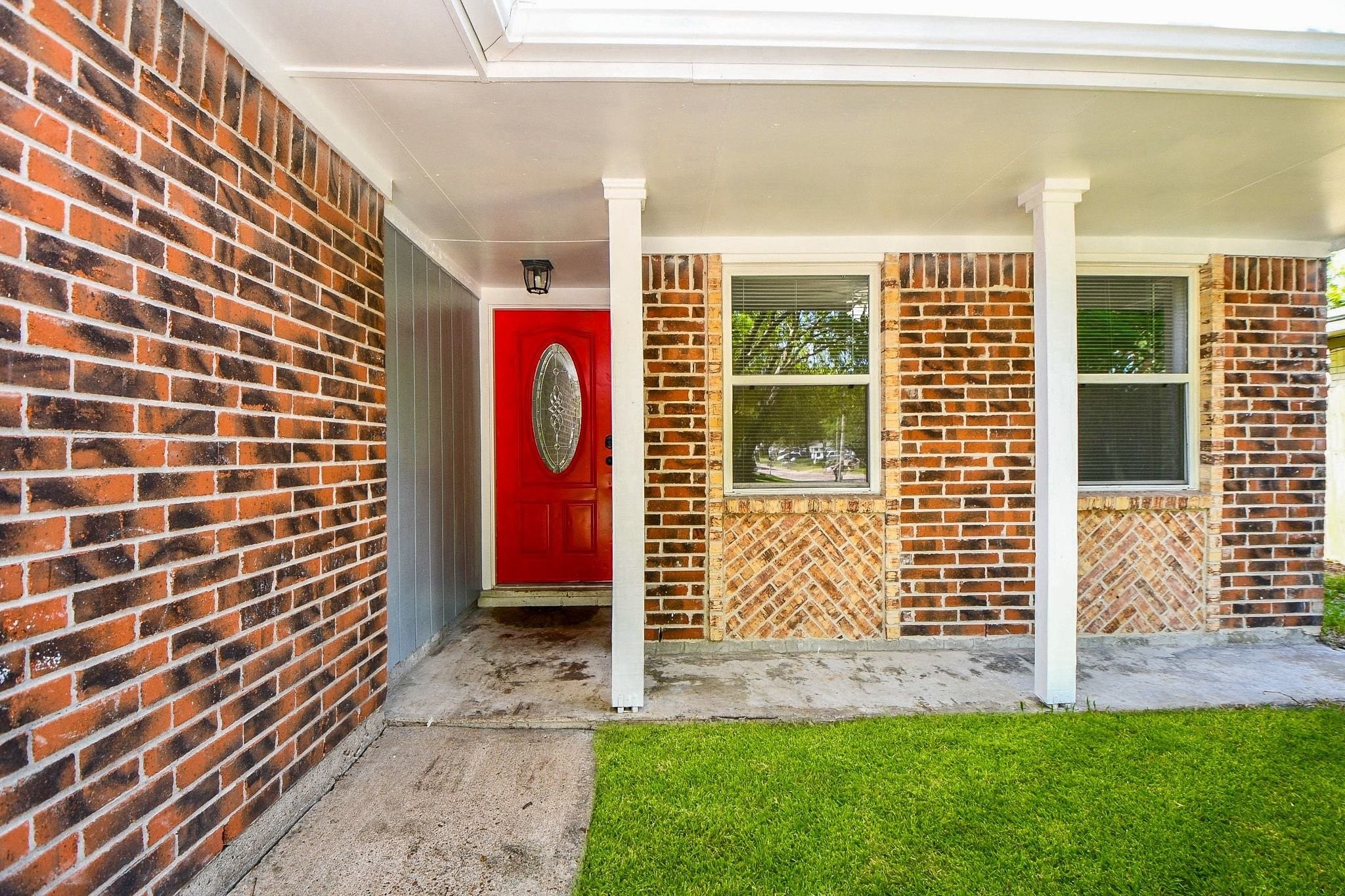 Exceptional curb appeal begins here! Enjoy morning coffee on this spacious covered porch, accented by timeless brickwork, clean architectural pillars, and a bold red front door that makes a memorable first impression.