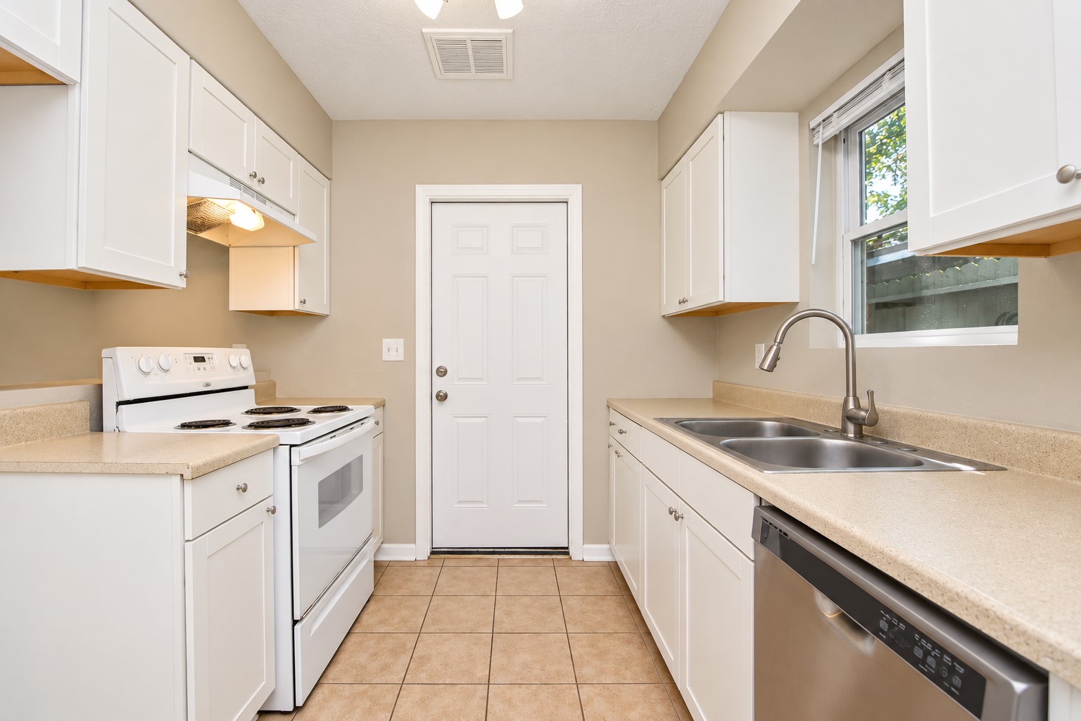 his kitchen has plenty of storage and dishwasher that saves time and your back from having to wash dishes at the sink.  The door leads directly to the garage so bringing groceries straight to the kitchen is a nice feature!