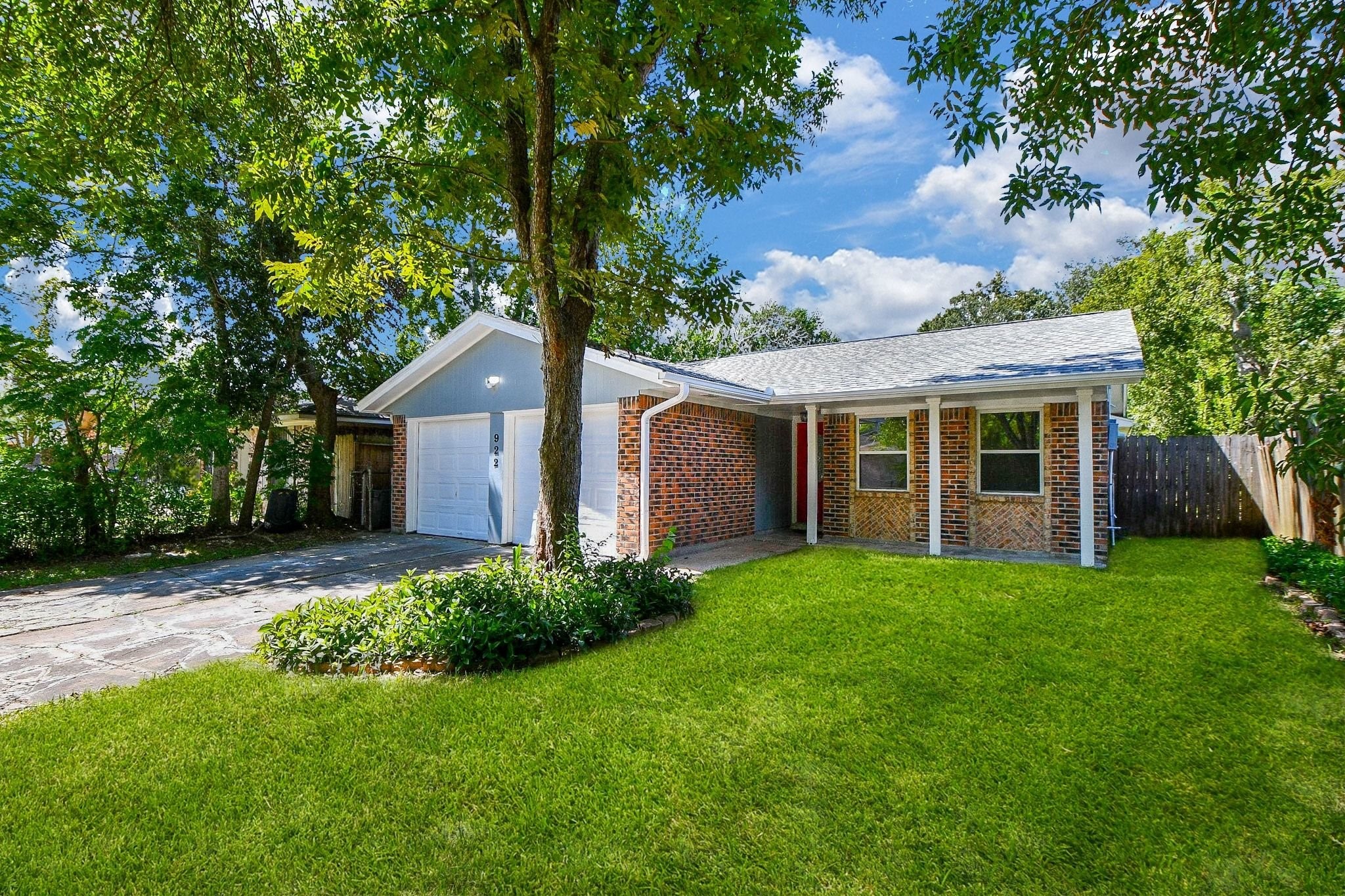 Nestled under the generous shade of this mature pecan tree this house stands out as one of a kind.  Gorgeous!