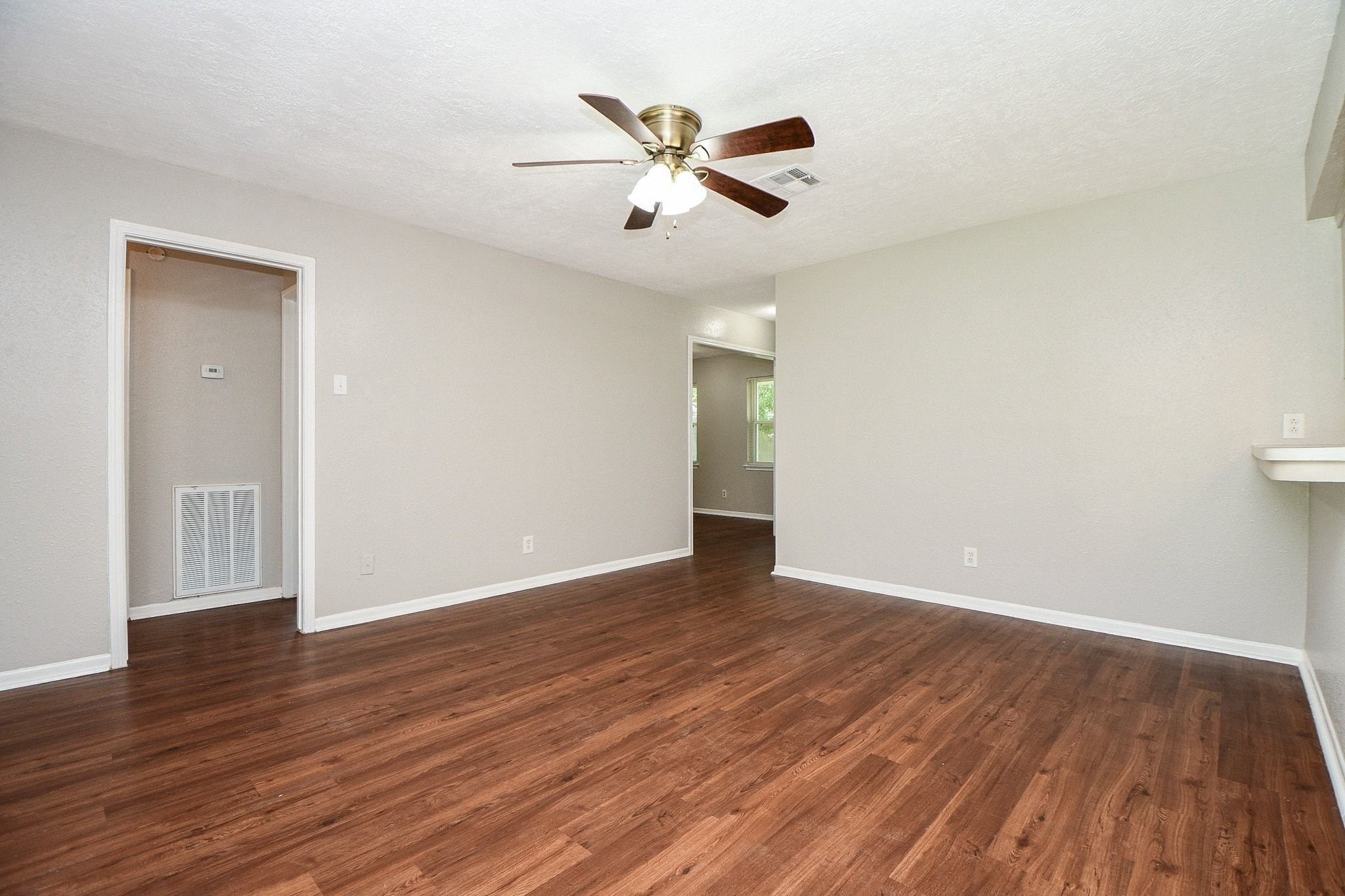 Rich, new laminate flooring adds warmth and durability to the living space, creating a welcoming flow throughout the home.