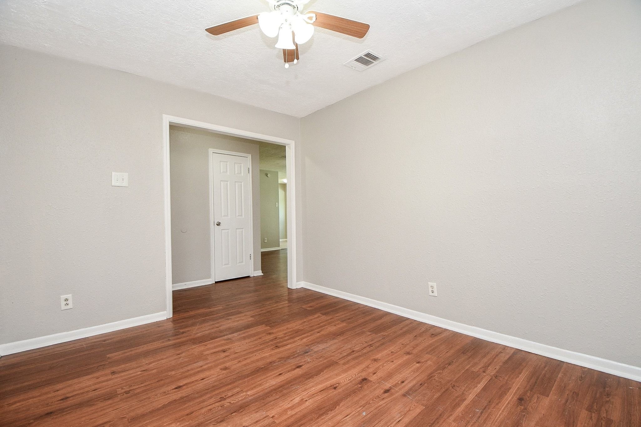 Flex Room with an entryway coat closet being shown in the hall leading to the main living area.