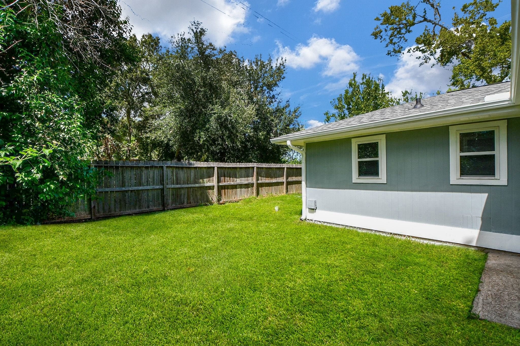 Fenced yard provides plenty of privacy and open green space for whatever you needs may be.