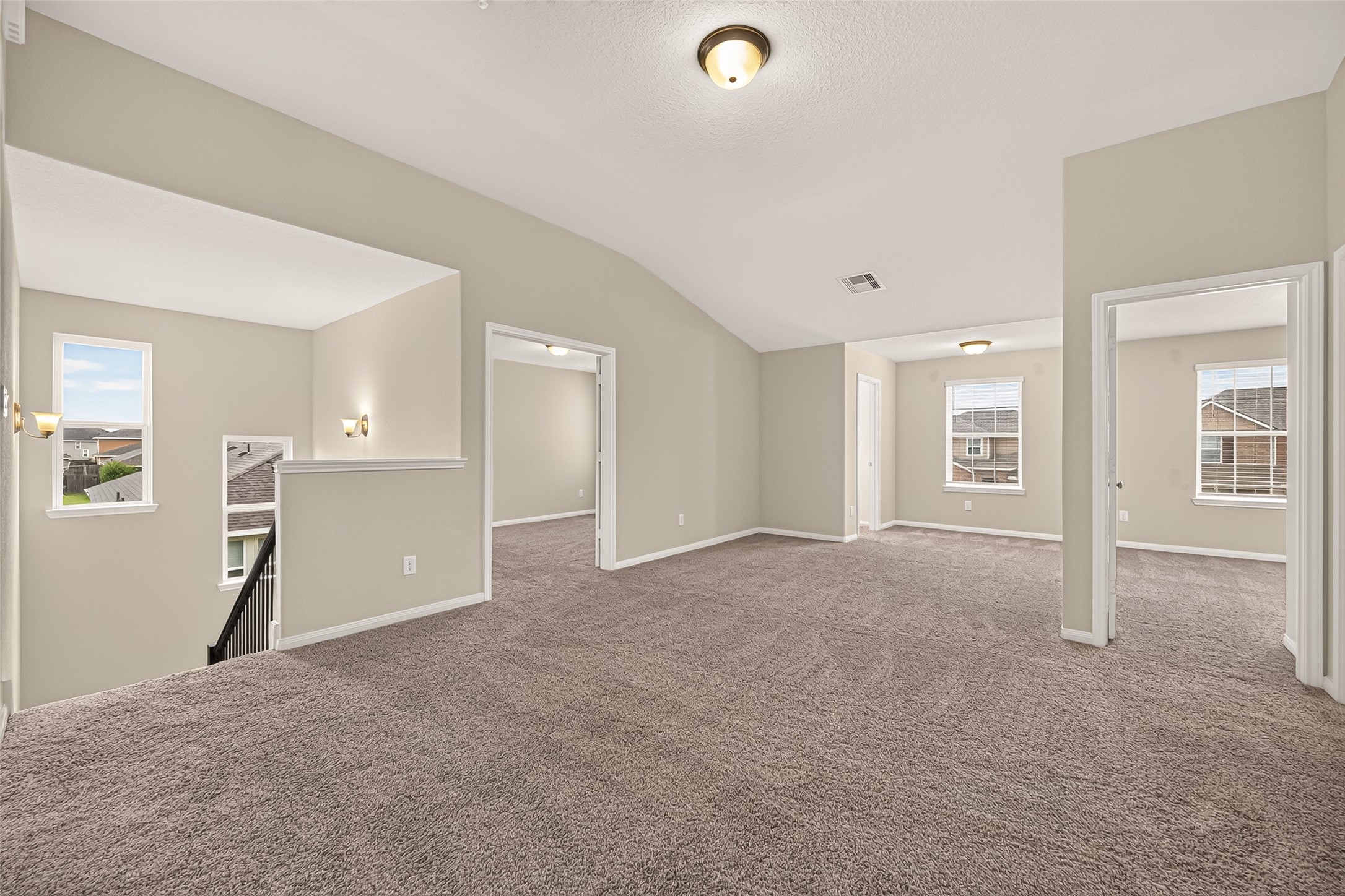Spacious and inviting, the 2nd floor carpeted living area features neutral tones, ample natural light, and convenient access to adjoining rooms, perfect for versatile living arrangements.