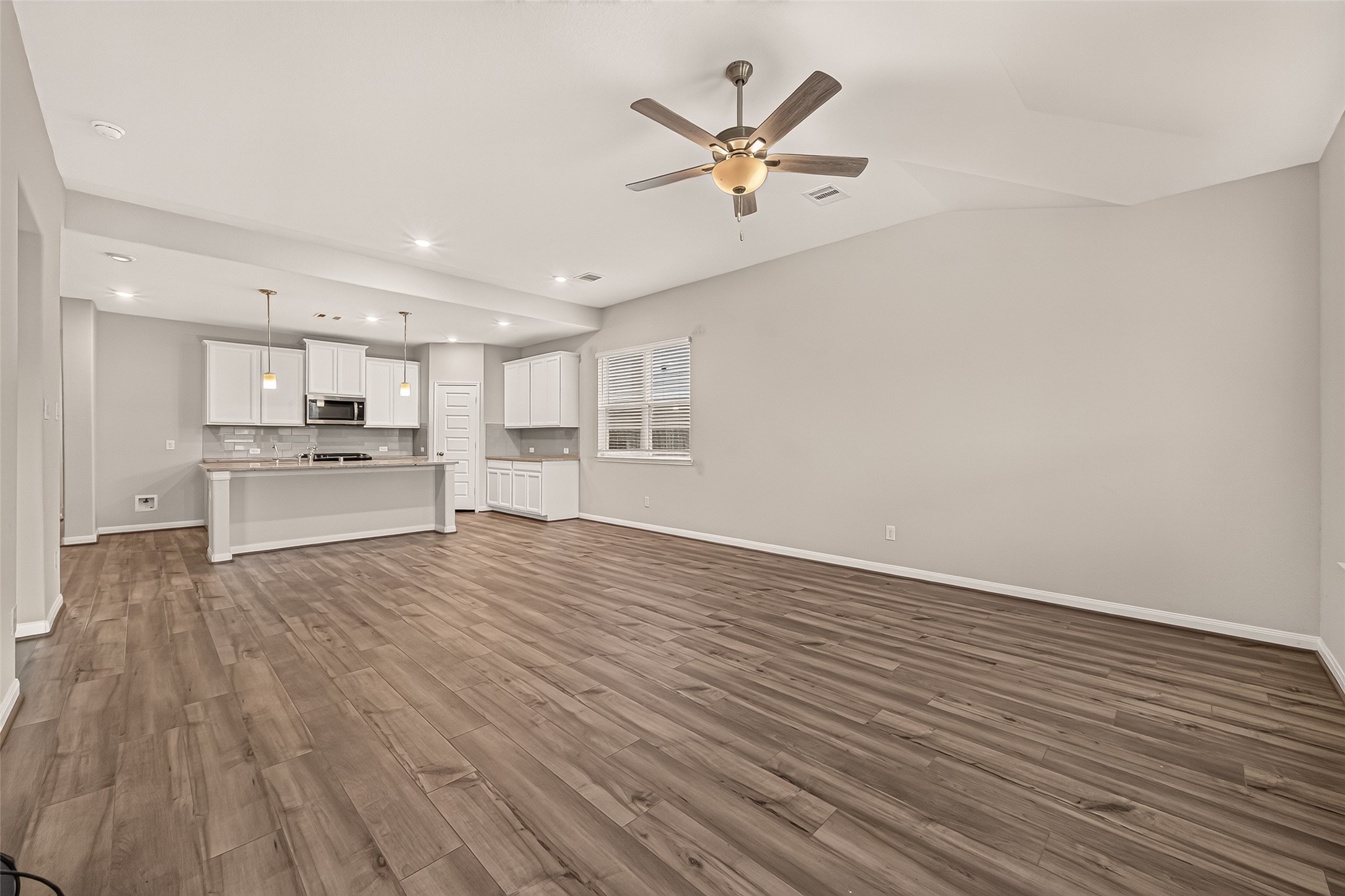 Experience seamless living with this open-concept kitchen flowing effortlessly from the first living area, featuring sleek cabinetry, modern appliances, and a spacious layout perfect for entertaining.
