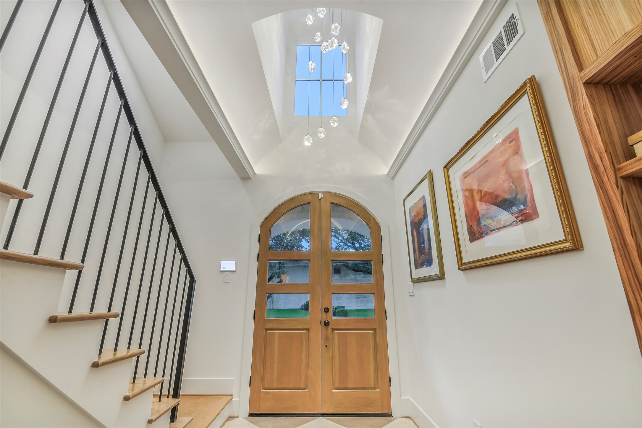 One of a kind ceiling with picture window to show off the beautiful light fixture. Entry feature double doors offering seamless entry into the home.