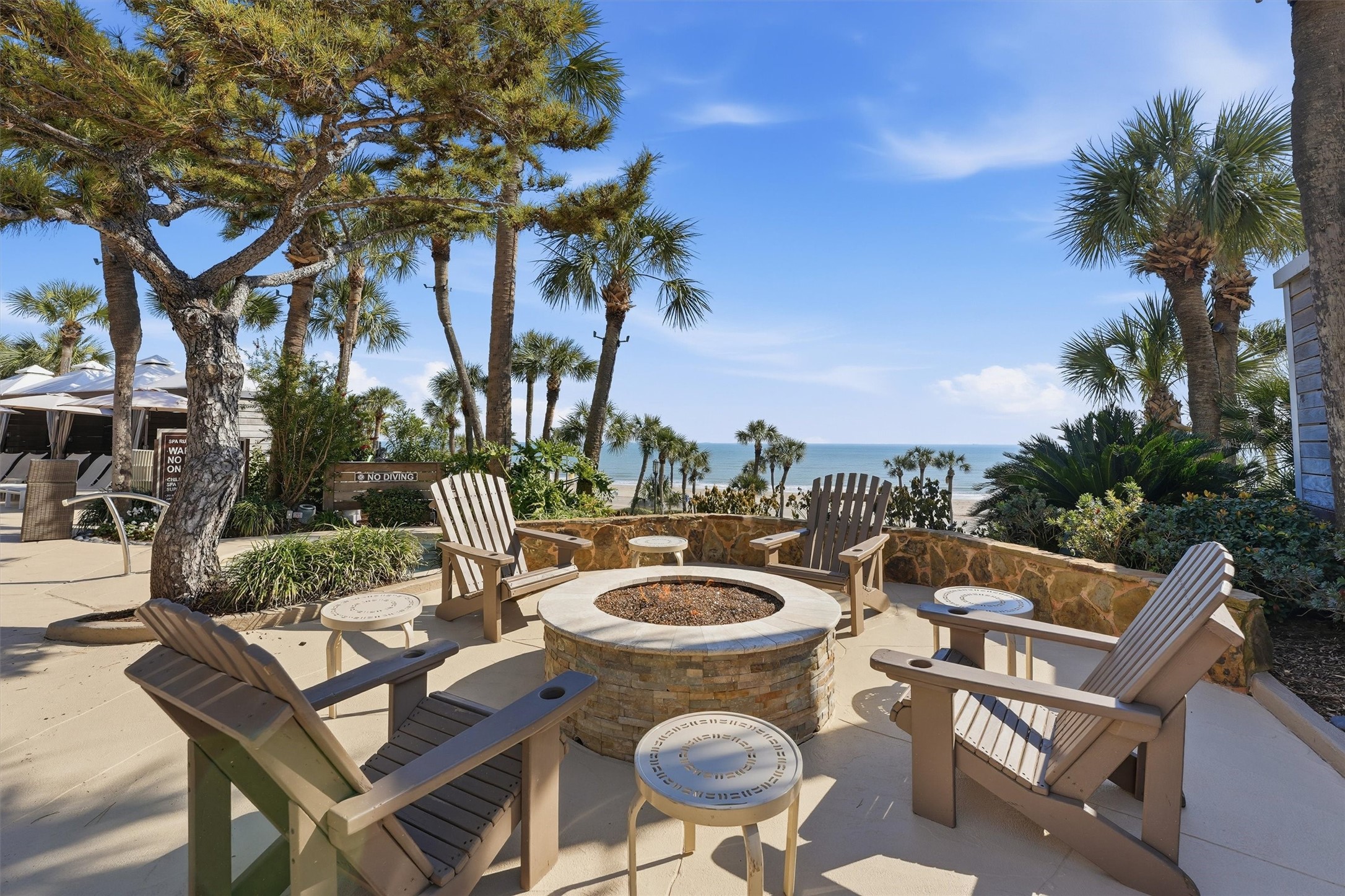 Outdoor lounge spaces surround the pool, creating a relaxed setting for sunbathing, socializing, or enjoying quiet moments between beach outings.