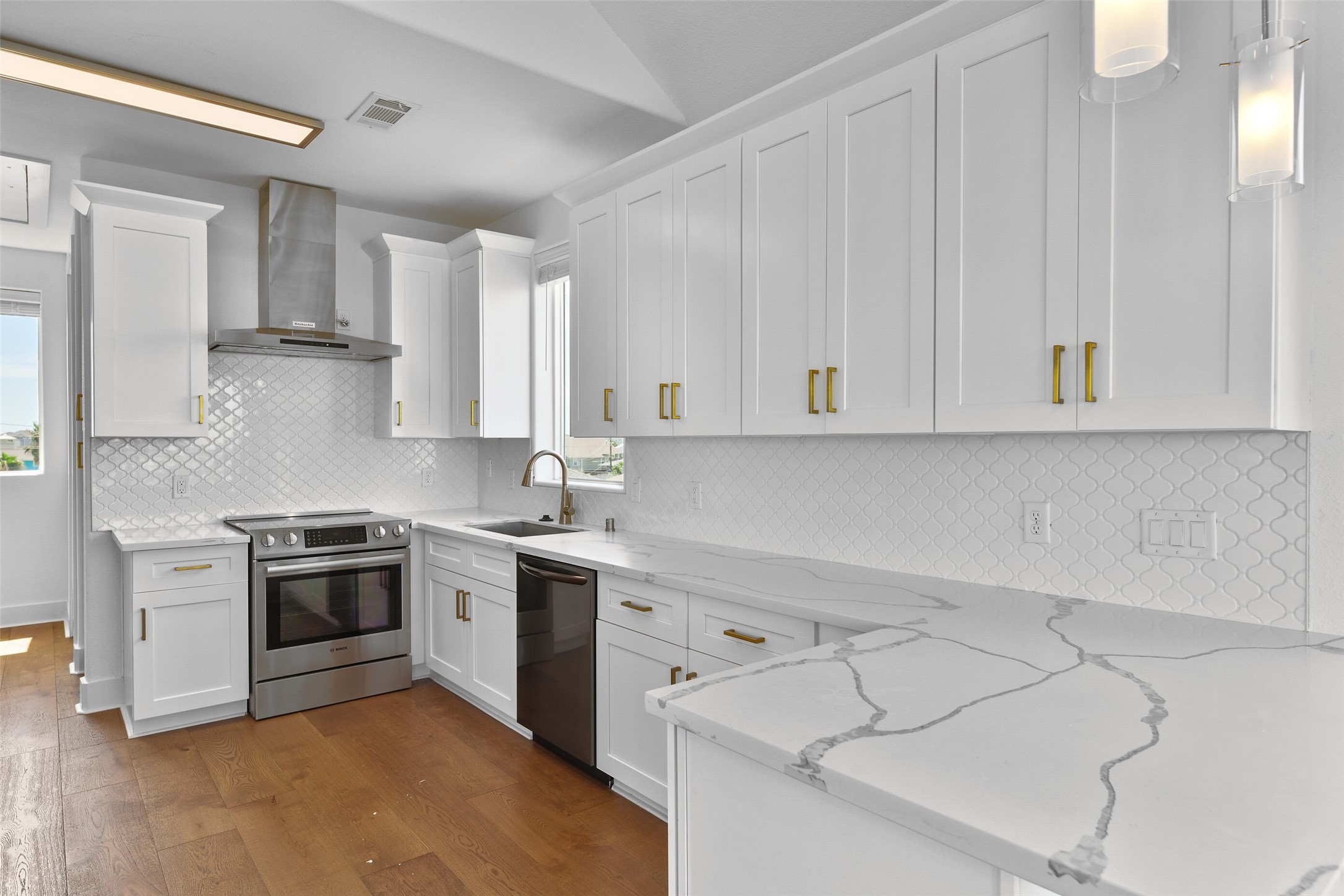 Quartz countertops, and a stunning tile backsplash a show stoppers .