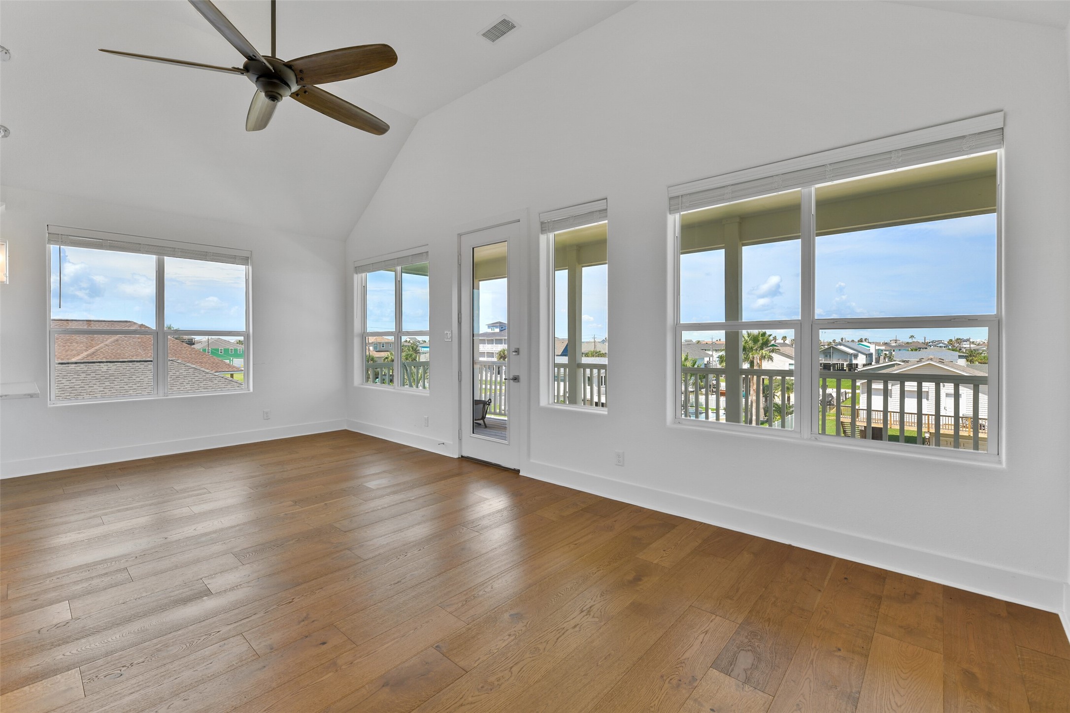 The living area is open to both the kitchen and dining area, and is surrounded with natural light through the many windows.