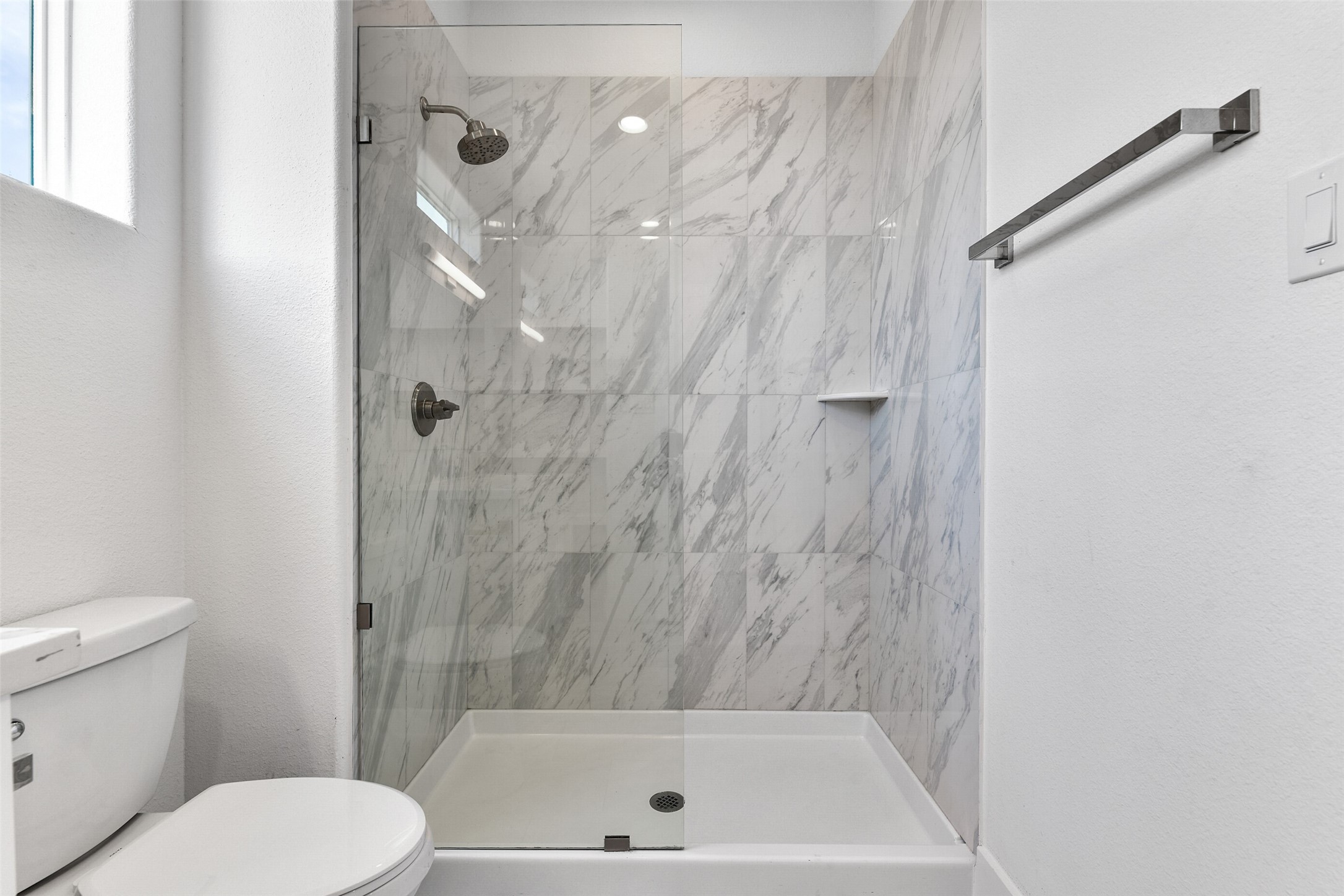 The tile work is beautiful in the walk-in shower.