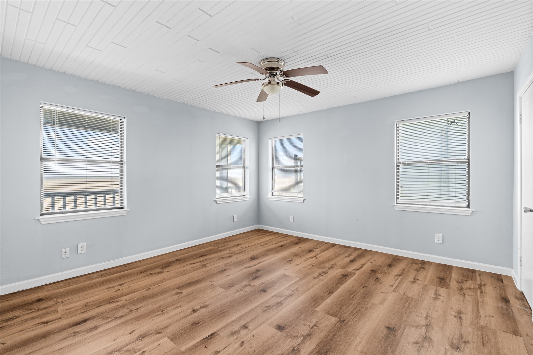 Designed with simplicity in mind, the bathroom features a large glass-enclosed shower, an expansive vanity, and an airy layout that feels both fresh and functional.