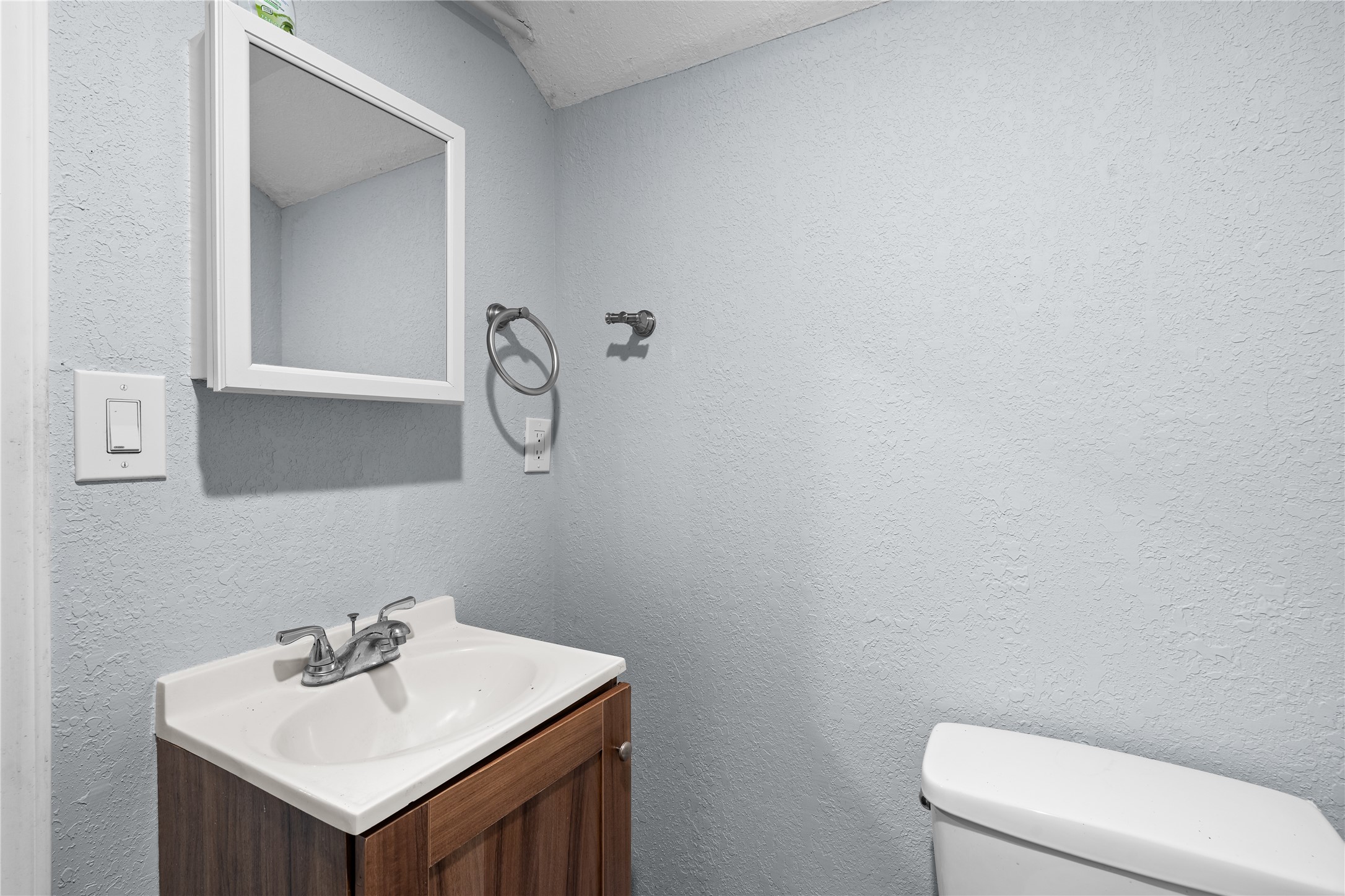 Simple, functional, and conveniently located, the lower-level bath includes a walk-in shower for added ease.