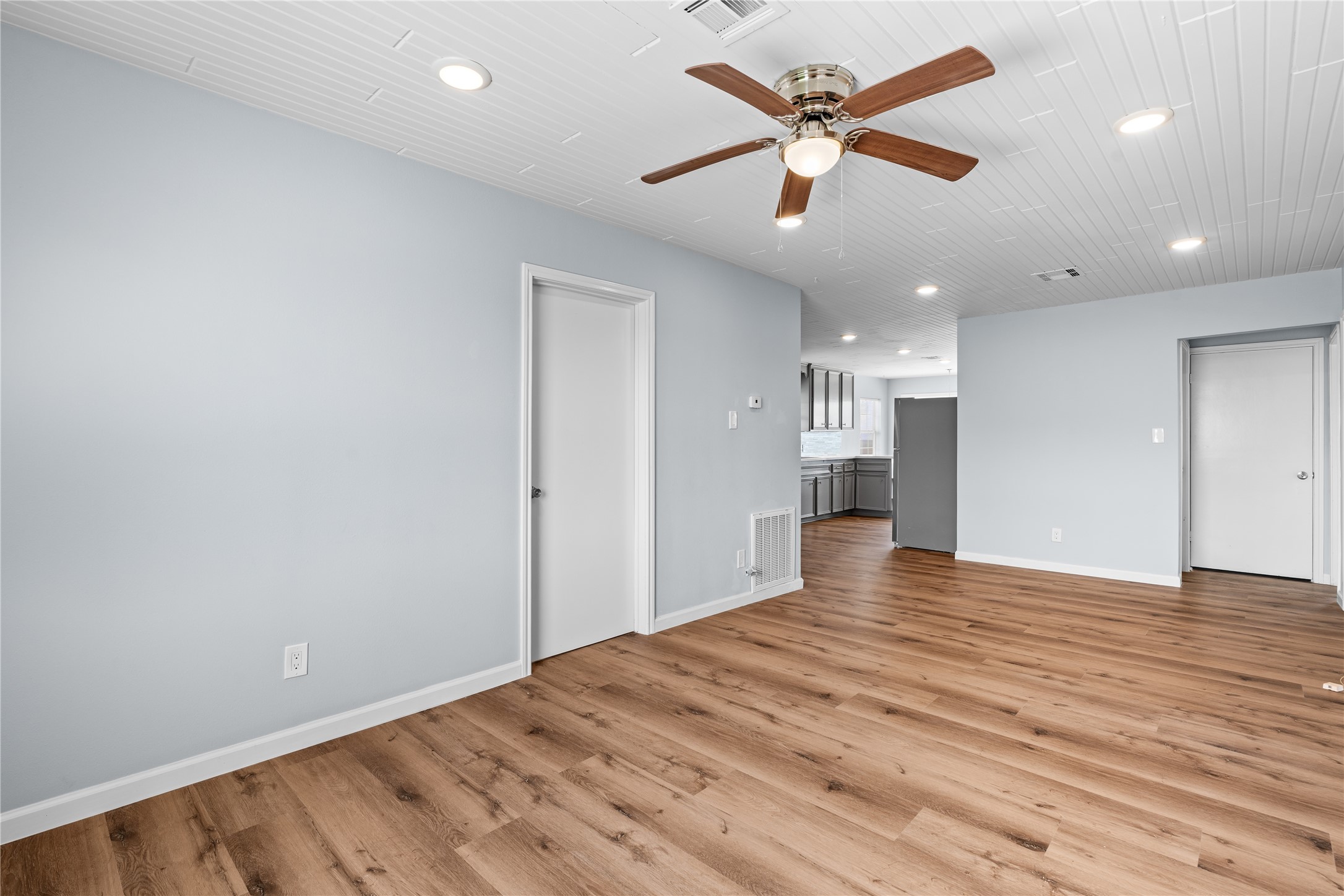 The spacious primary bedroom offers a peaceful retreat, with room to unwind and a bright, airy atmosphere that complements the home's coastal setting.