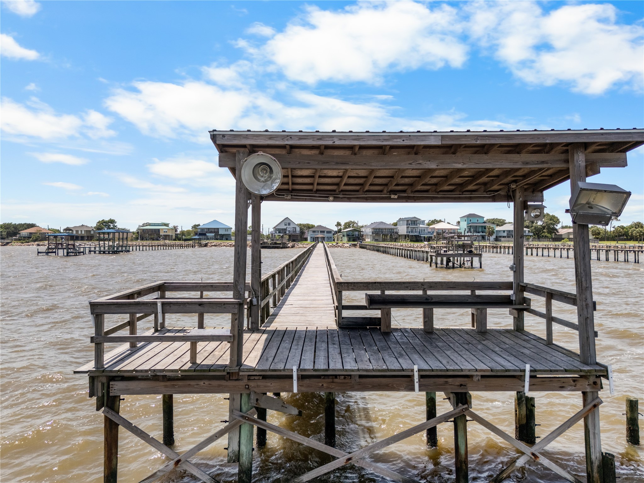 The best seat on the bay is waiting. Whether you're reeling in the day's catch or unwinding beneath the shade, this covered dock was made for slow coastal afternoons.