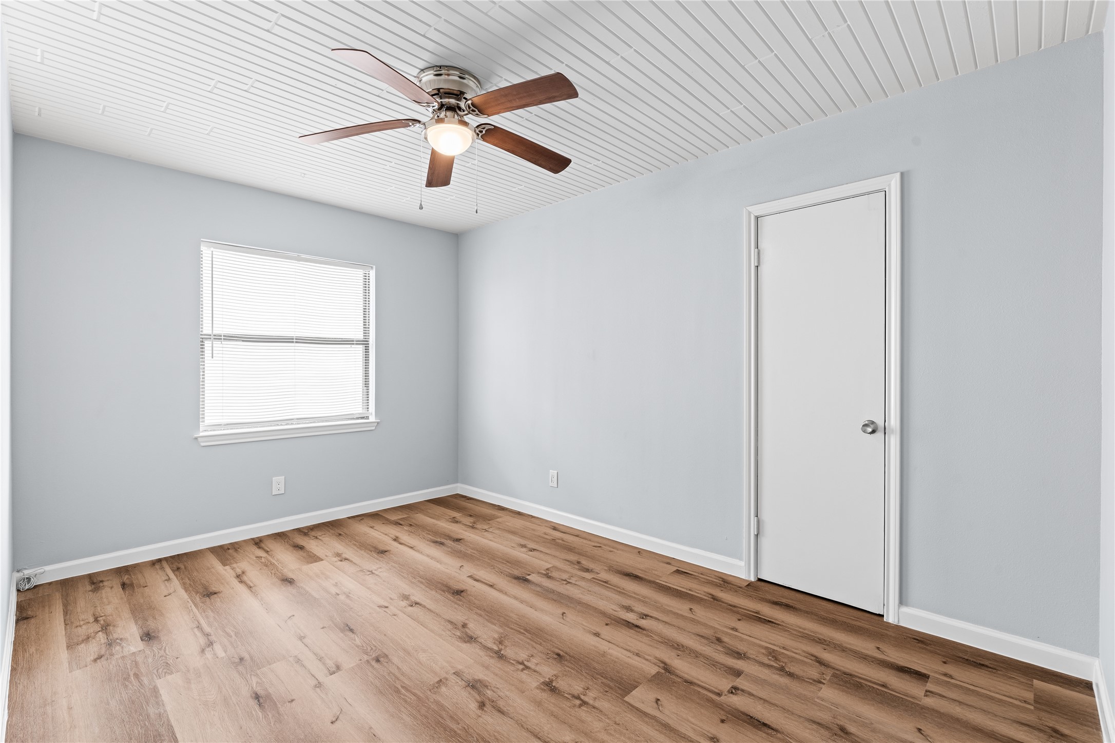 Dual windows invite natural light from multiple angles, giving this bedroom a bright, open atmosphere throughout the day.