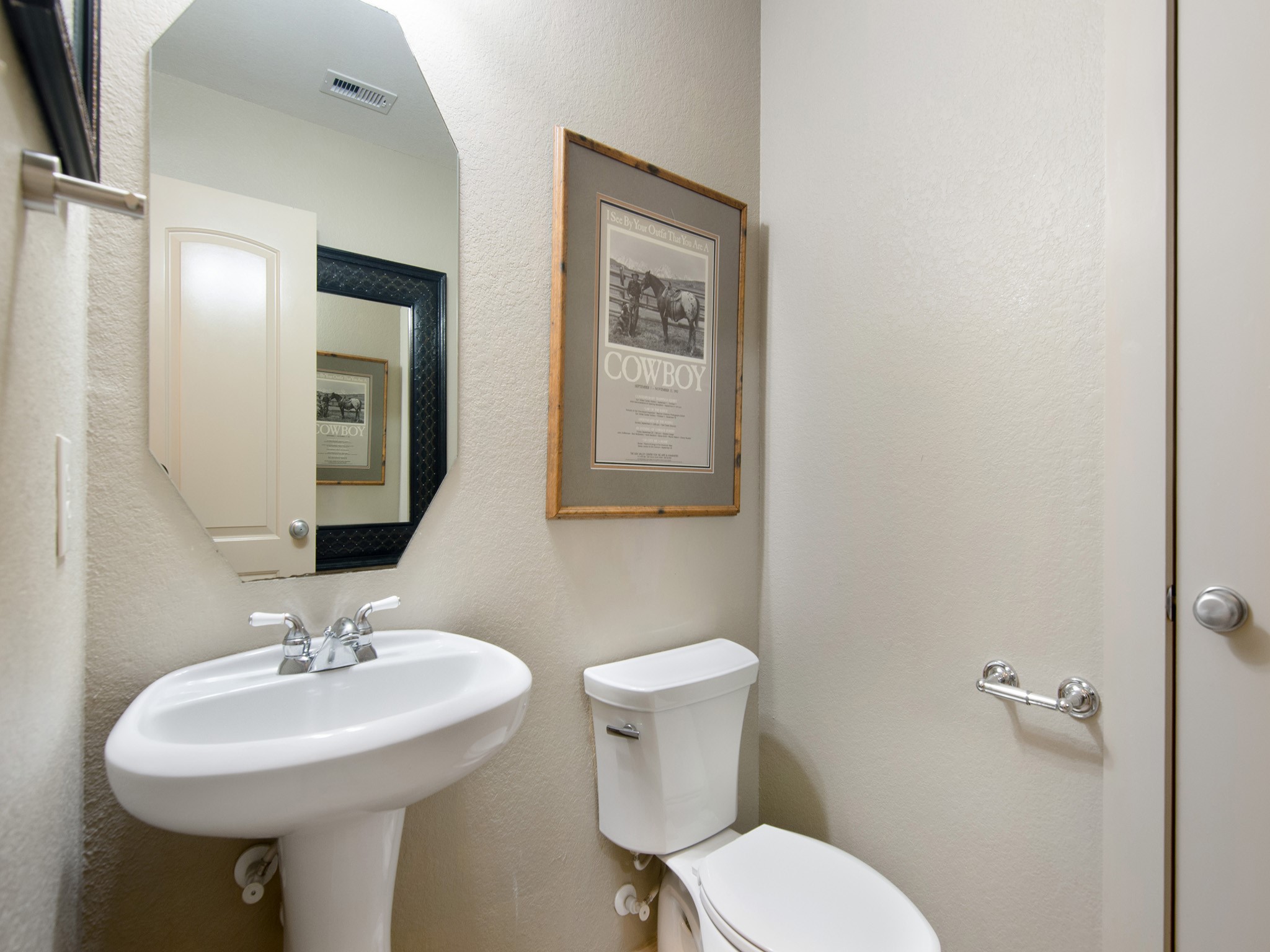A conveniently located guest bath and nearby storage closet add everyday functionality to the main level.