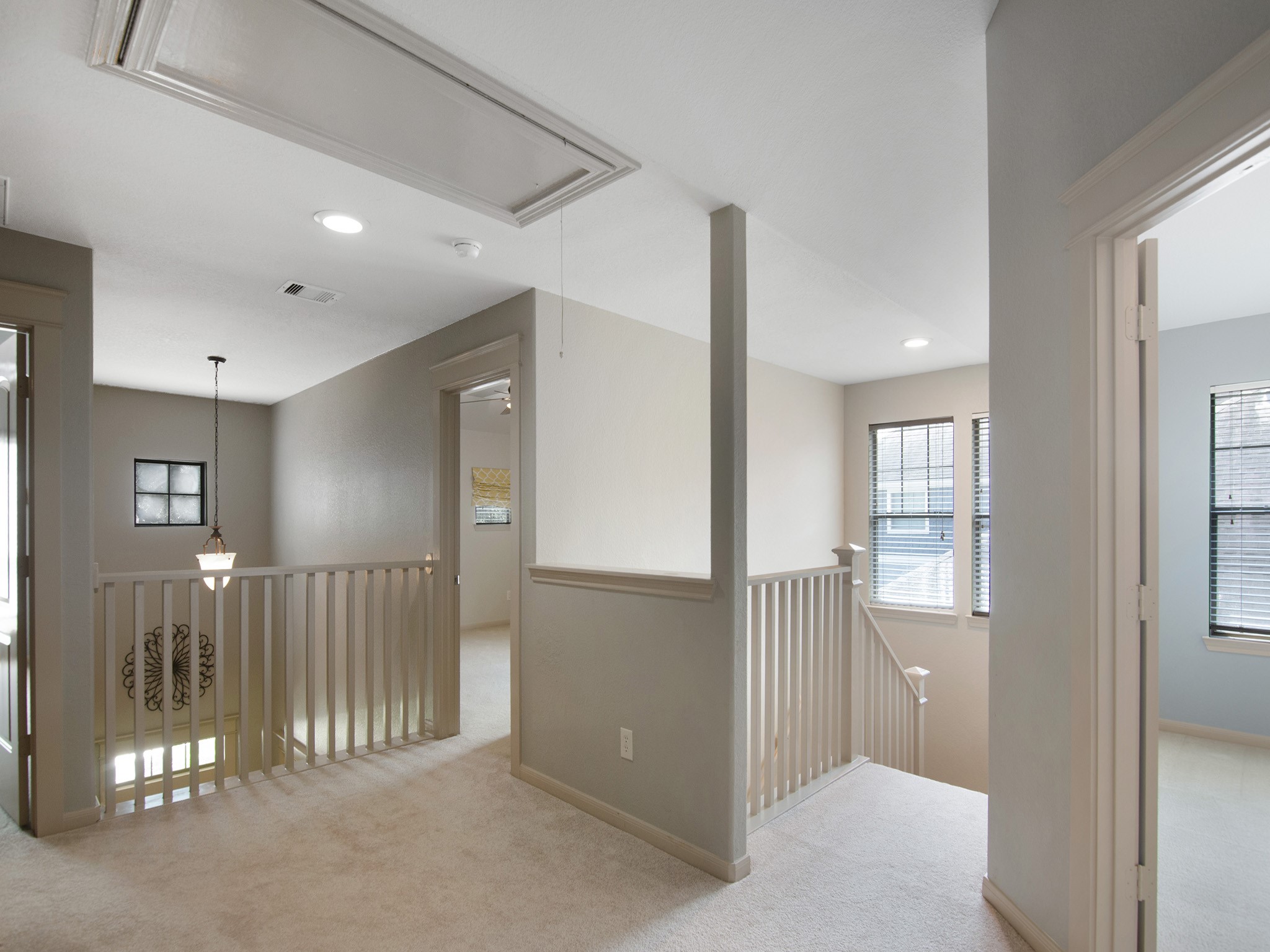 Bright upstairs landing with plush carpeting and access to three bedrooms, a full bath and a game room.