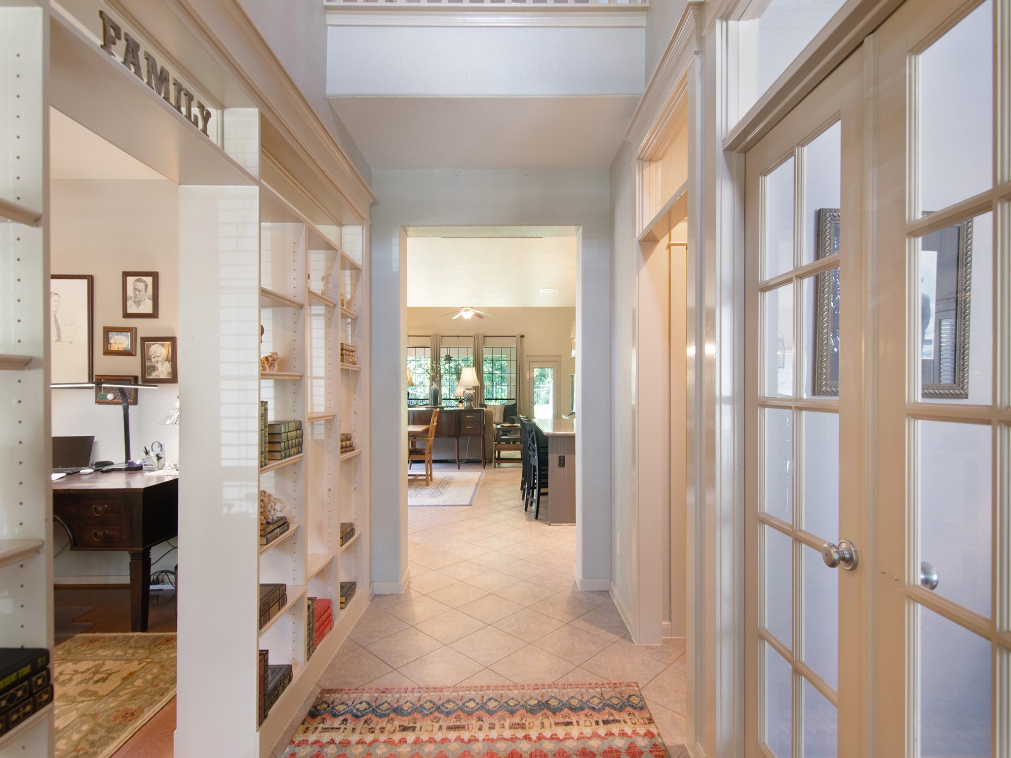 The custom bookshelves provide the perfect place to showcase treasured books, artwork and collectibles while the durable tile flooring adds beauty and easy maintenance throughout the main living areas.