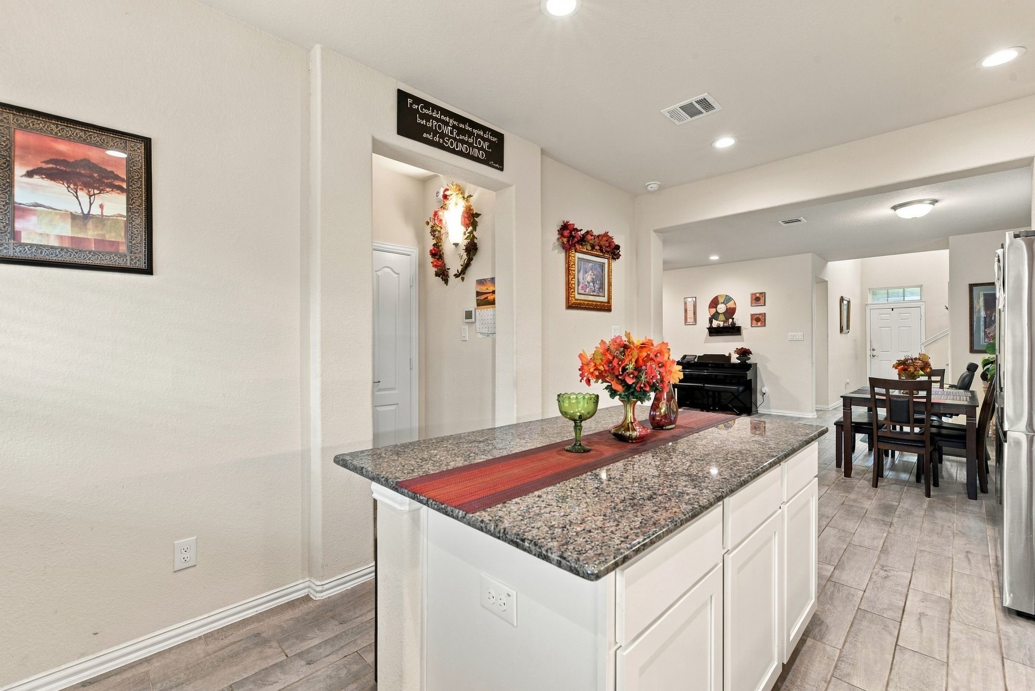Sleek granite island, seamlessly flowing into an open-concept dining and living area, perfect for entertaining.
