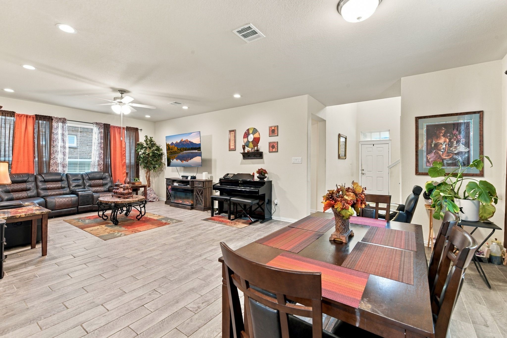 Open-concept living and dining area featuring modern tile flooring, ample natural light, perfect for entertaining and family gatherings.