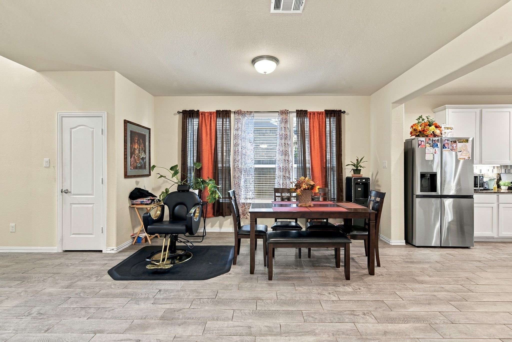 Bright dining area, large windows for natural light, and an inviting open layout leading to the modern kitchen.