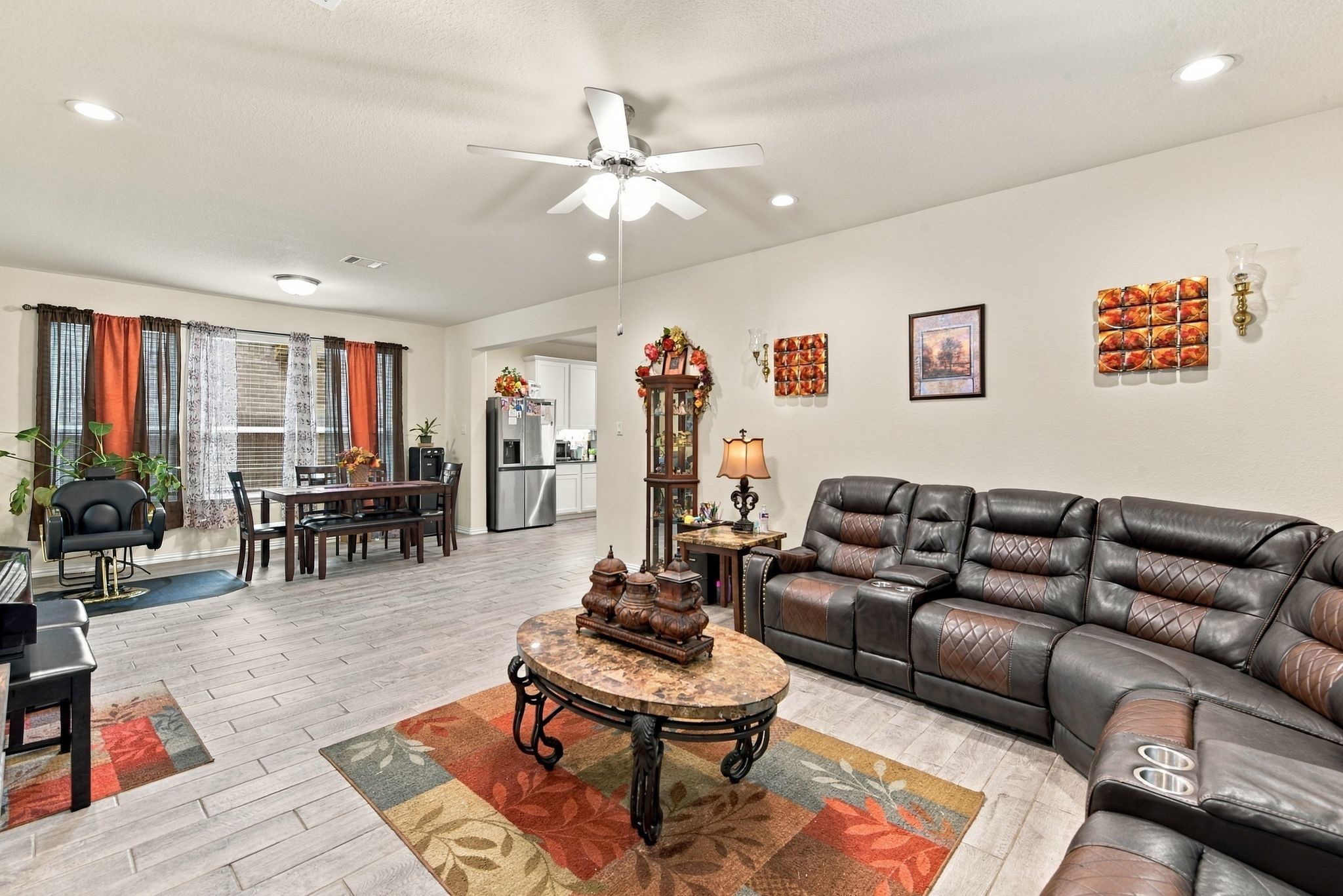 Spacious living area, seamlessly connected to a dining space with abundant natural light.