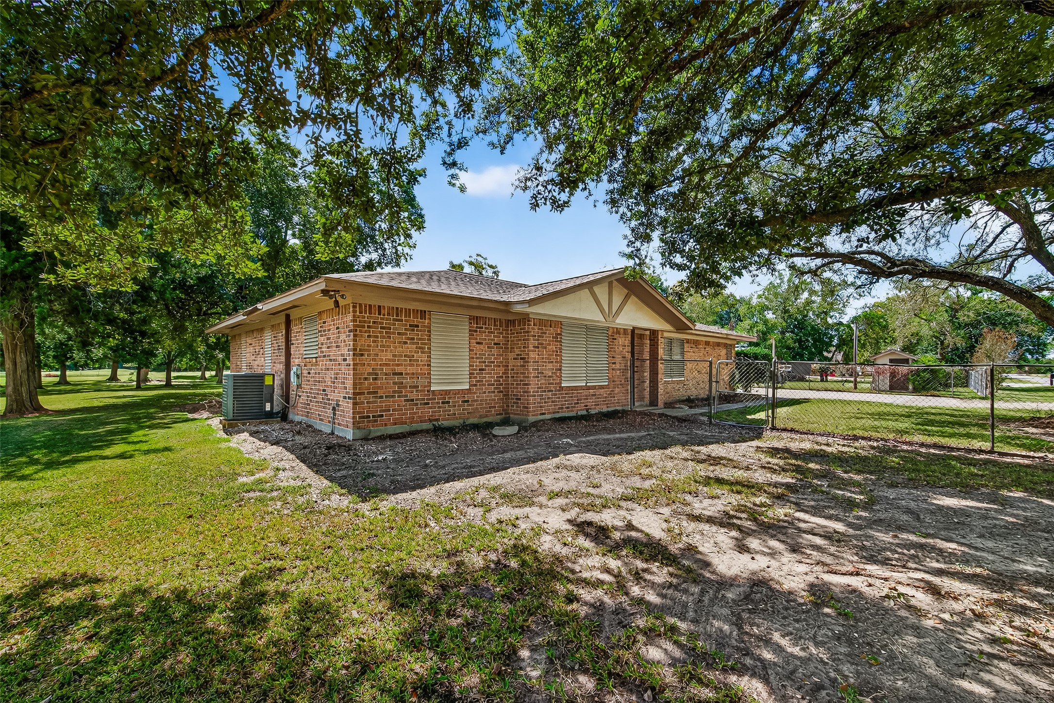 Charming brick home with a spacious, fenced yard and mature trees providing ample shade. Ideal for privacy and outdoor enjoyment.