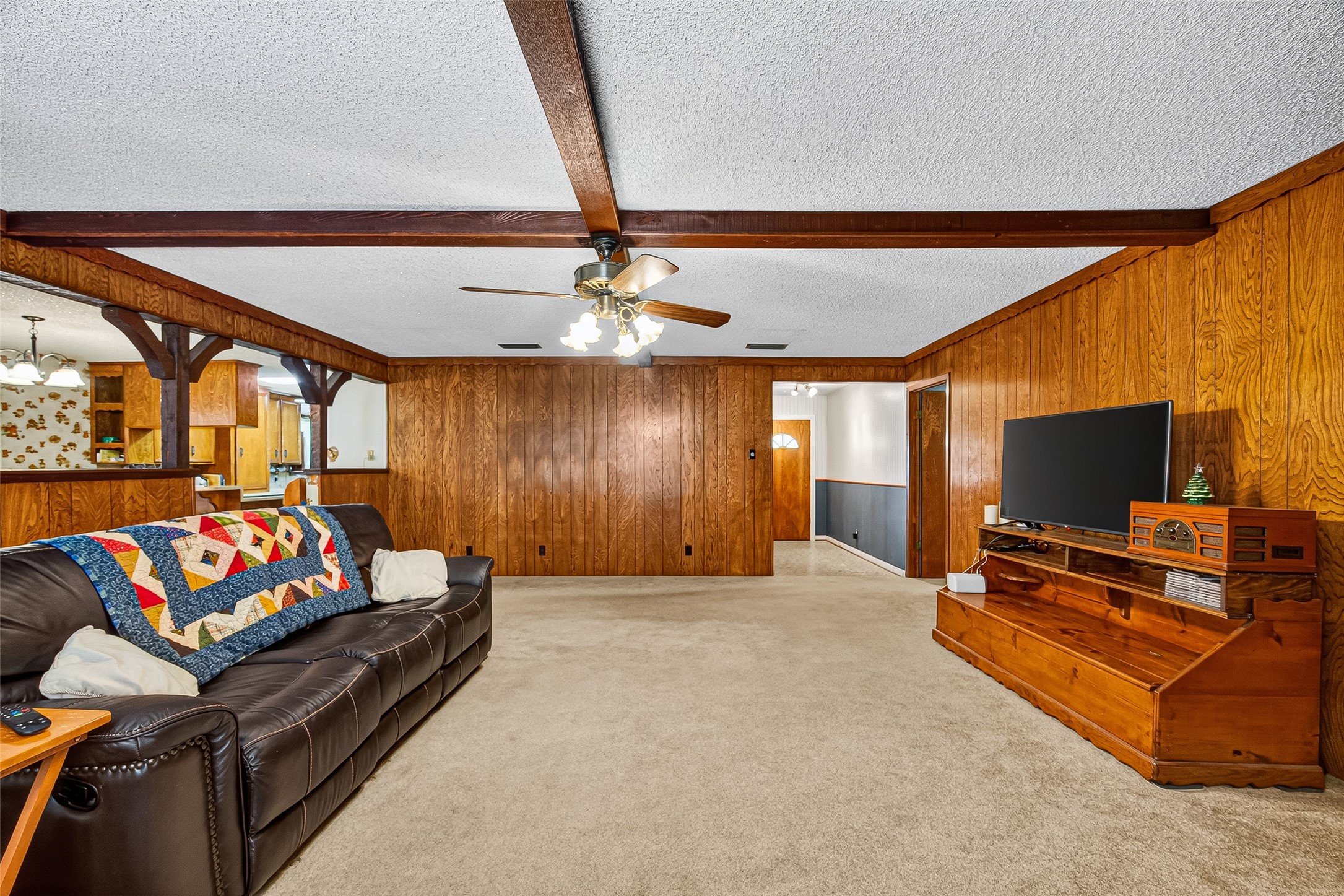 This cozy living room is open to the kitchen, providing a warm and inviting atmosphere, perfect for family gatherings.