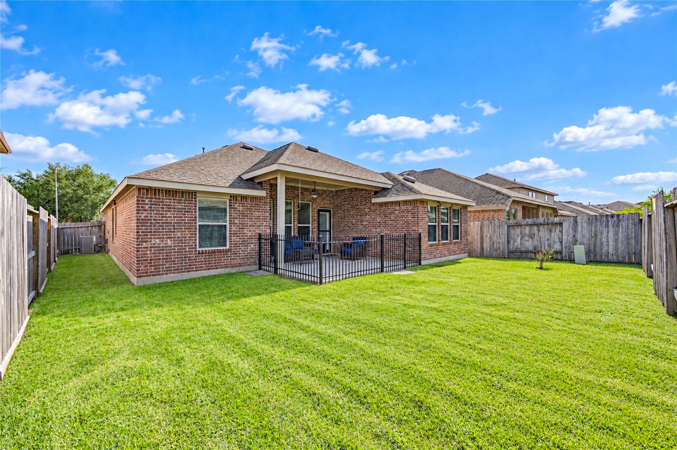 The back of the home looks over a fully fenced, level yard with plenty of room to play.