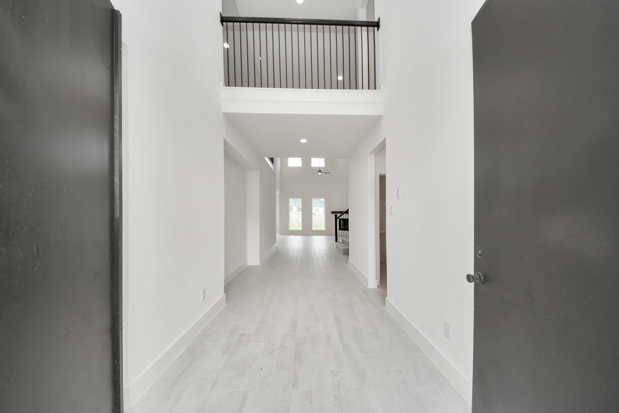 As you step into the threshold of this luxurious home, you'll soon be welcomed by an elegant glass door (to be installed). Inside, soaring ceilings amplify the spaciousness, while the refined wood-look tile flooring and oversized baseboards exude sophistication and charm. Sample photo of completed home with similar floor plan. Actual colors and selections may vary. As you step into the threshold of this luxurious home, you'll soon be welcomed by an elegant glass door (to be installed). Inside, soaring ceilings amplify the spaciousness, while the refined wood-look tile flooring and oversized baseboards exude sophistication and charm. Sample photo of completed home with similar floor plan. Actual colors and selections may vary.