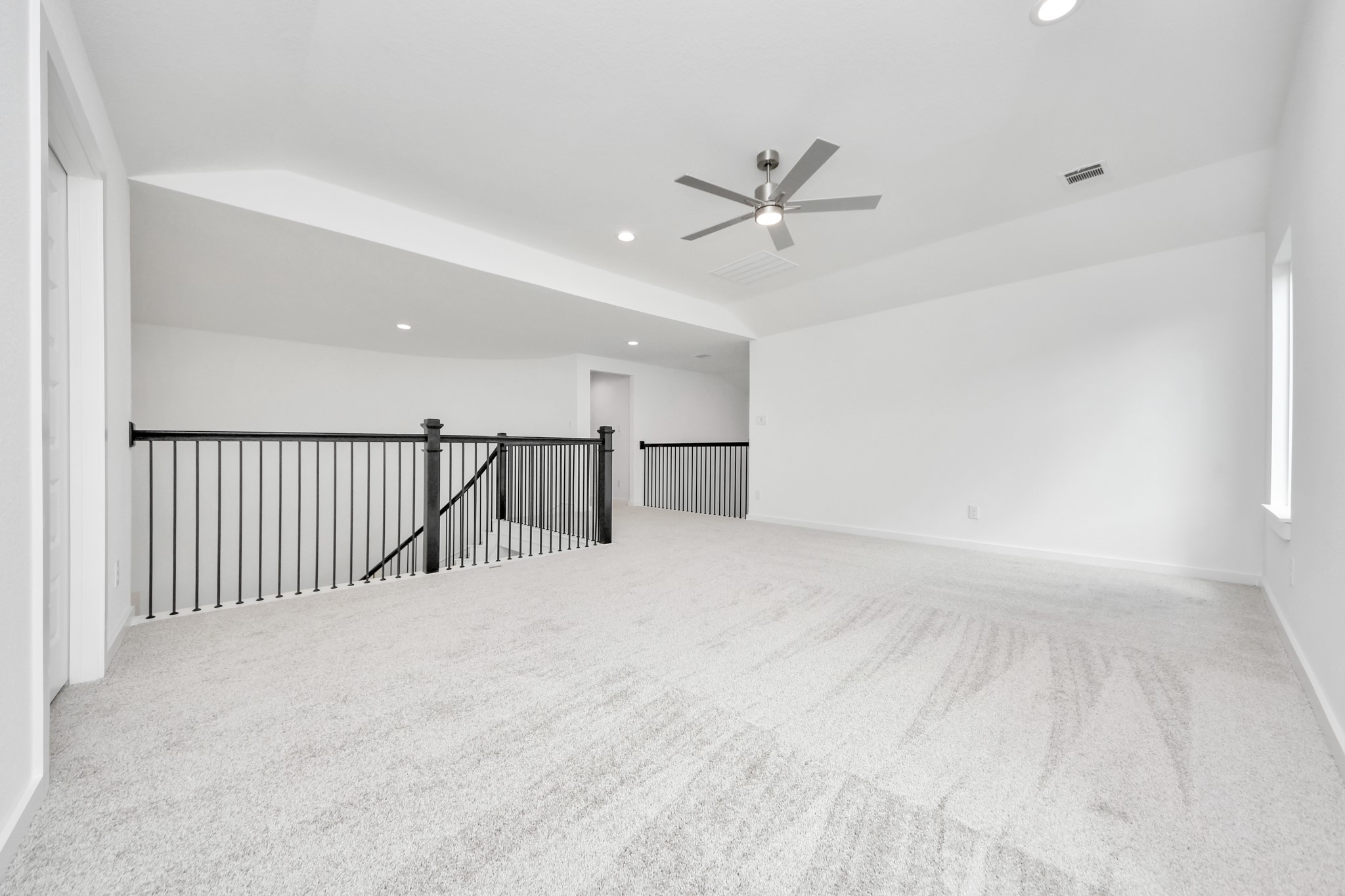 Ascend to relaxation in this fantastic game room! Ideal for both casual gatherings and adult gaming, it boasts plush carpet, lofty ceilings, custom paint, and ample windows for abundant natural light. Sample photo of completed home with similar floor plan. Actual colors and selections may vary.