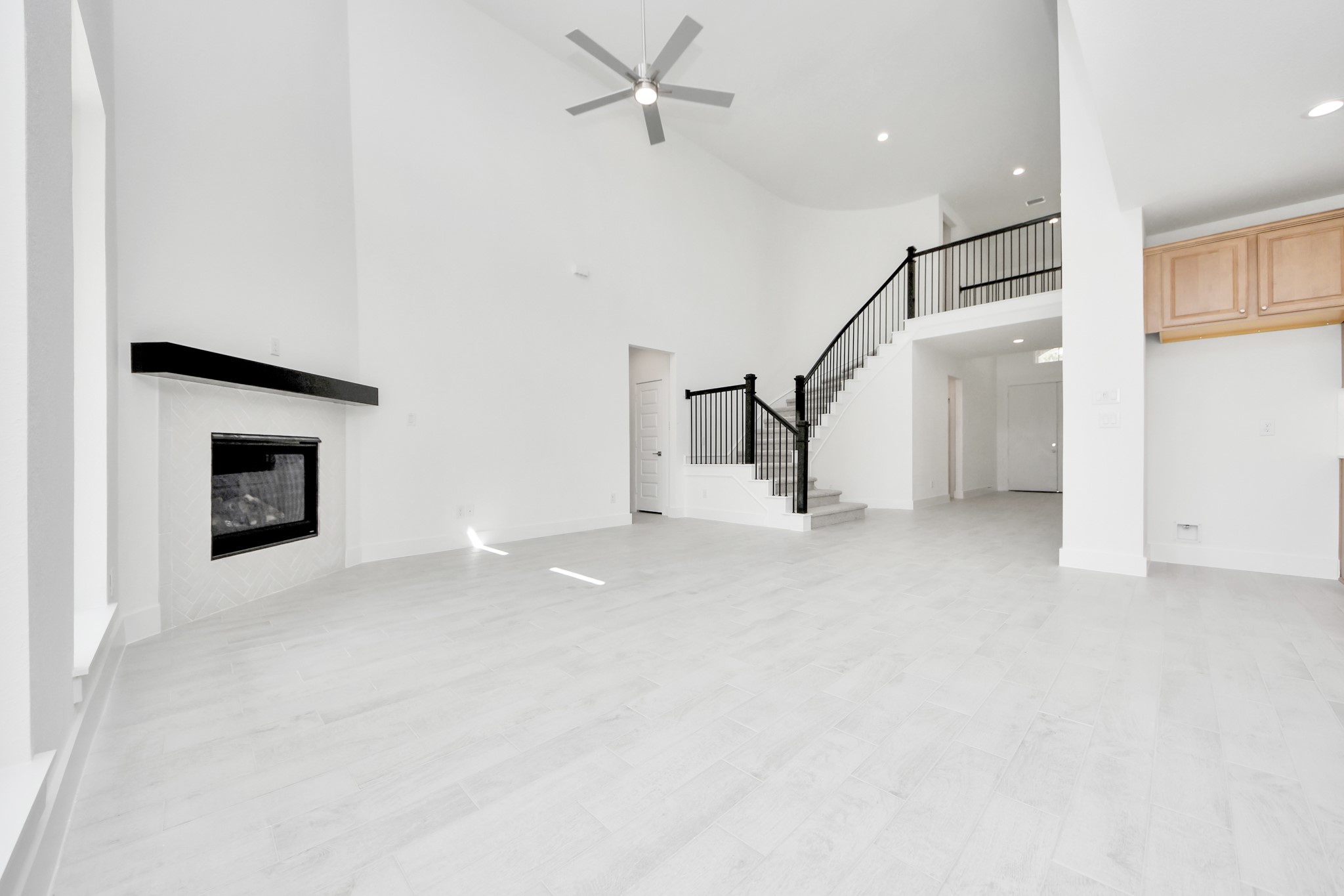 Family room flooded with natural light through the expansive windows. The premium tile flooring adds a touch of luxury to the space, creating the perfect setting for relaxing moments and cherished gatherings with loved ones. Sample photo of completed home with similar floor plan. Actual colors and selections may vary. Family room flooded with natural light through the expansive windows. The premium tile flooring adds a touch of luxury to the space, creating the perfect setting for relaxing moments and cherished gatherings with loved ones. Sample photo of completed home with similar floor plan. Actual colors and selections may vary.